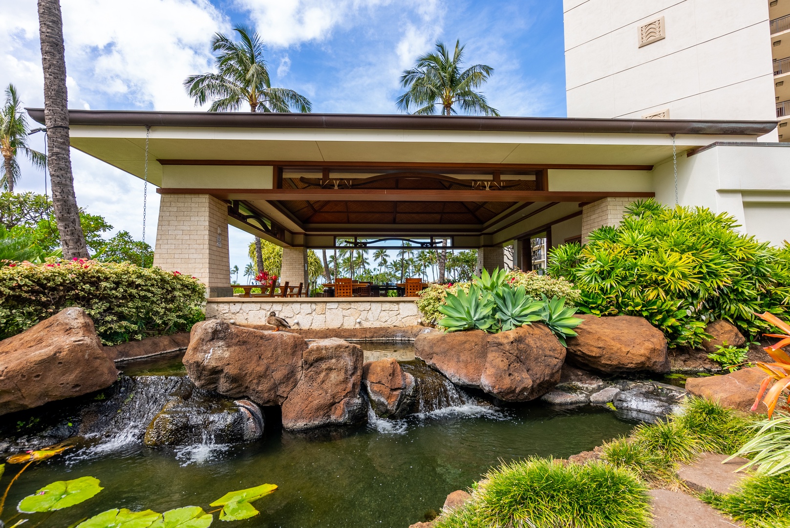 A rock waterfall greets you at the entry, koi ponds below the drive.