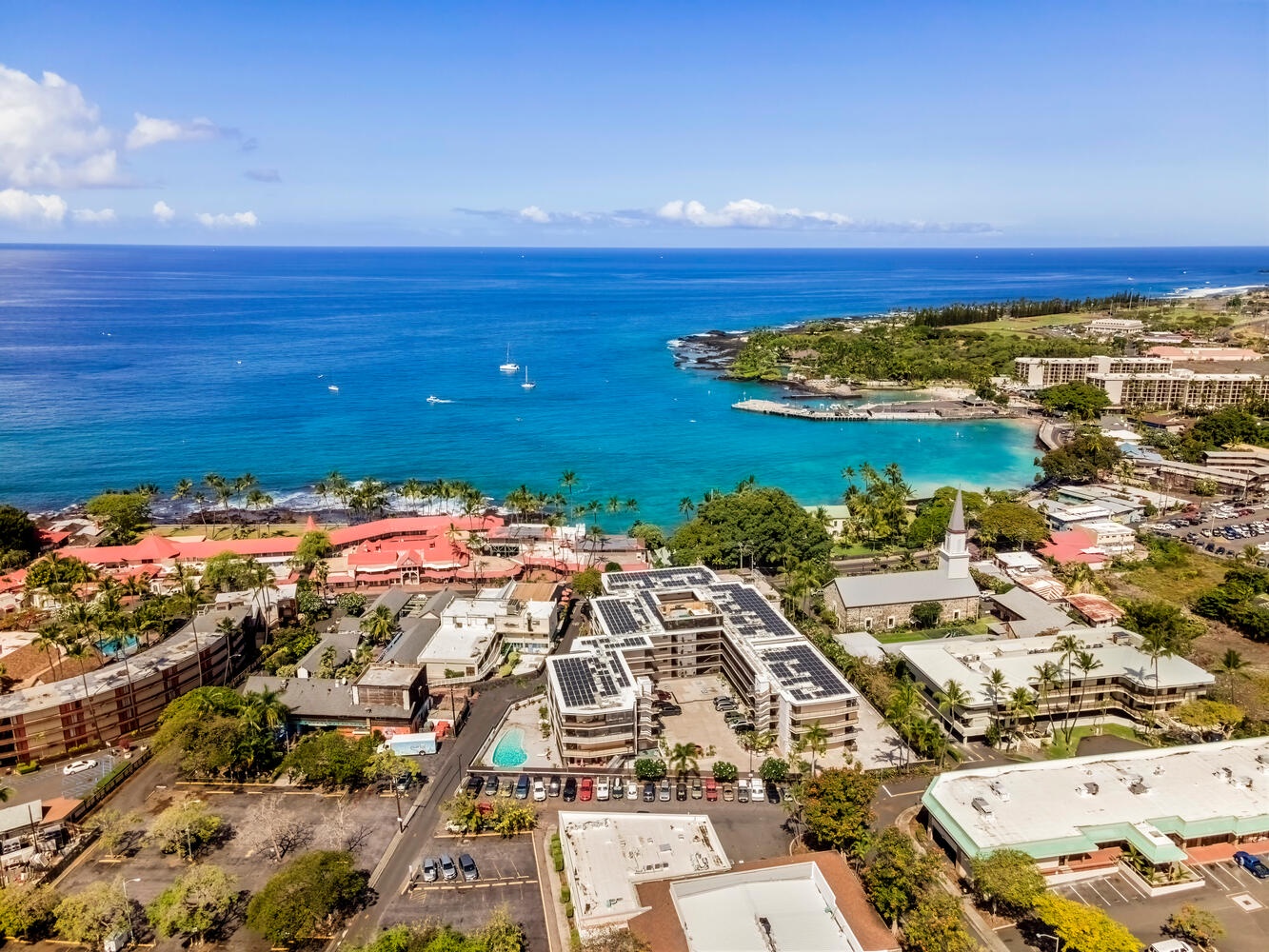 Kailua Kona Vacation Rentals, Kona Plaza 201 - Stunning aerial view of this oceanfront resort with pristine turquoise waters and tropical coastline stretching to the horizon.