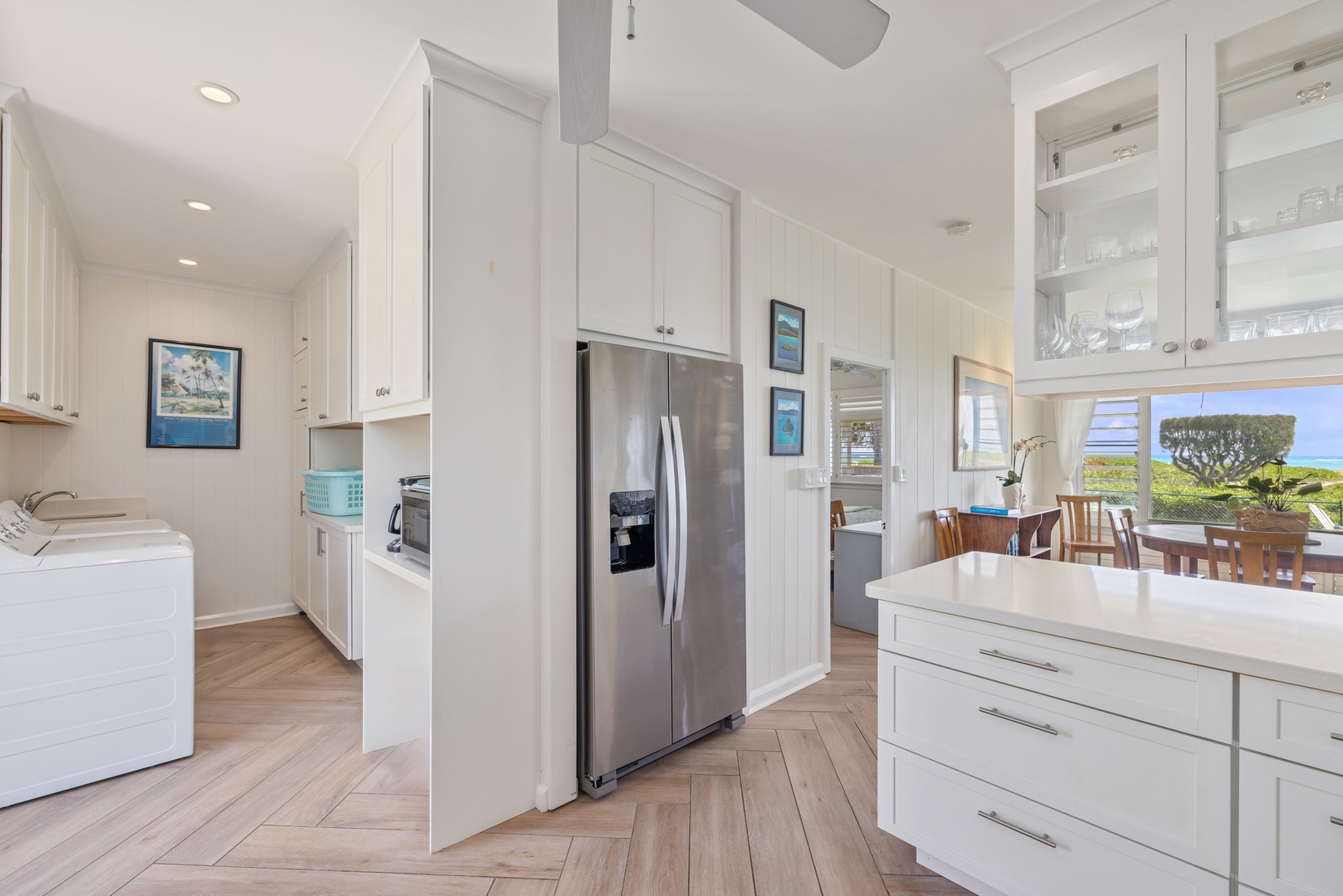 Kailua Vacation Rentals, Hale Moana Lanikai - The herringbone wood flooring and soft green backsplash add a touch of warmth and color, making it not only a functional space for cooking but also a stylish one for entertaining.