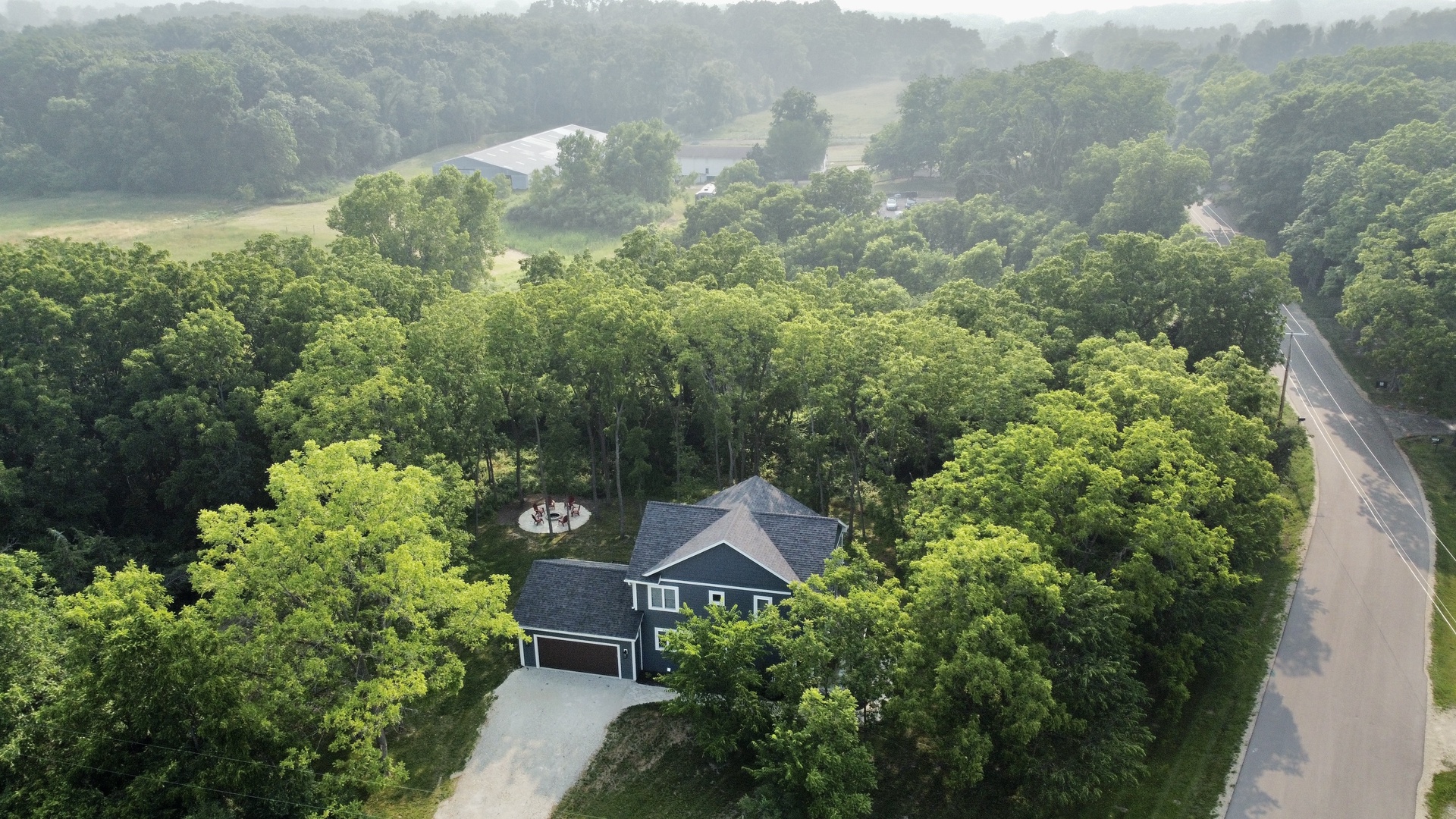 Aerial View of Home with Horse Farm in Background