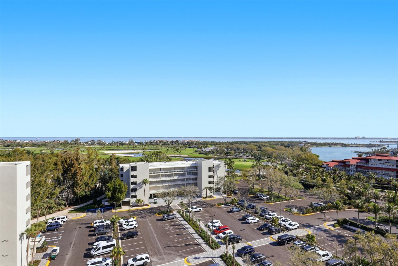 Elevated view showcasing the property's convenient parking facilities and prime location near golf courses and waterfront areas.