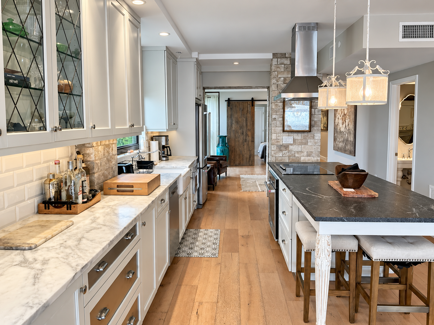 Brightened narrow kitchen with marble island