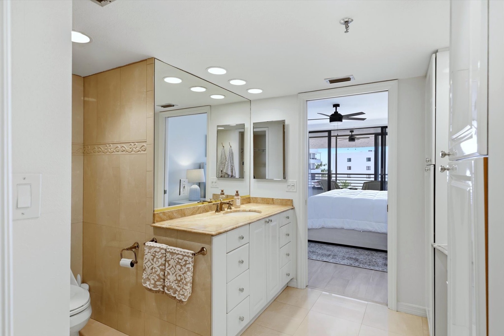 Your elegant ensuite bathroom features marble countertops, dual vanities, and opens directly to your private bedroom sanctuary.