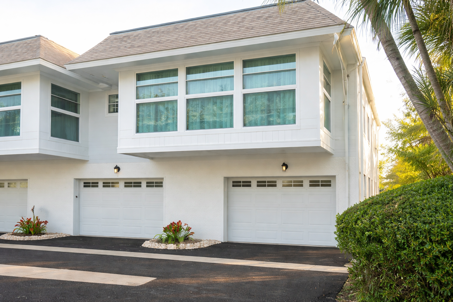 Modern white building with landscaped gardens and palm trees creates a welcoming tropical arrival experience.