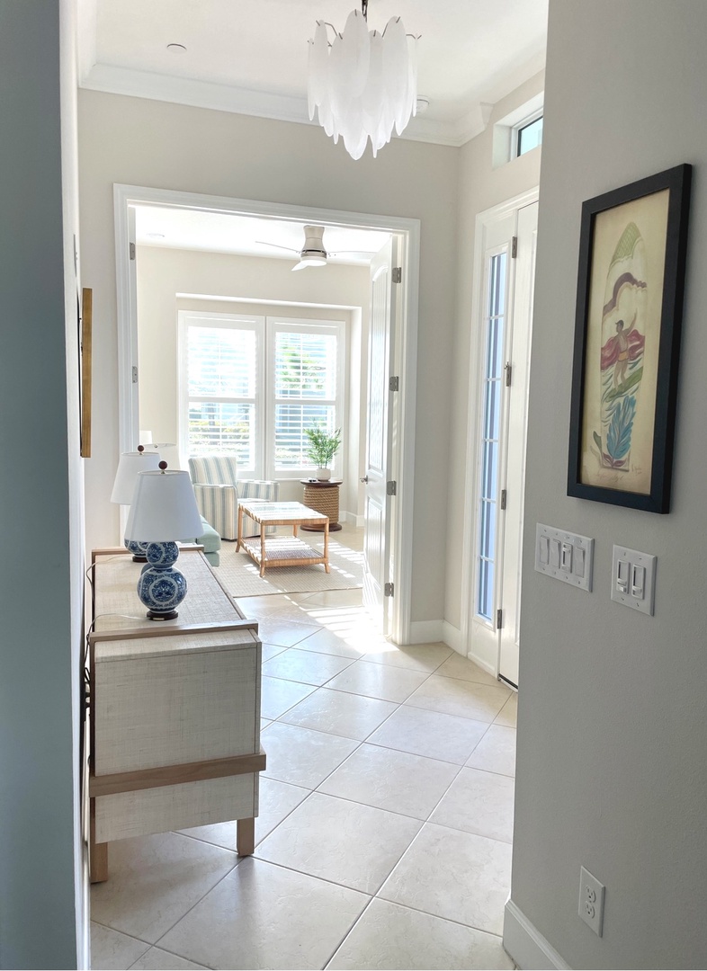 Step into your bright, sophisticated space where coastal elegance meets comfort through airy rooms and stylish furnishings.