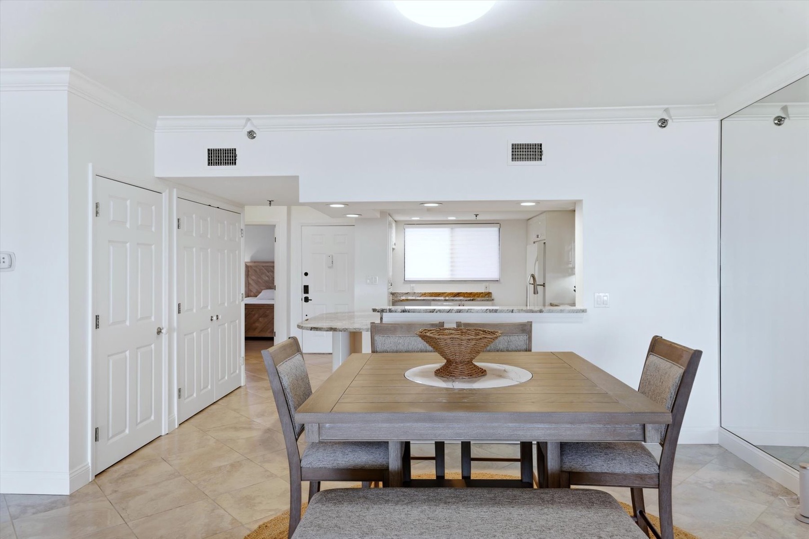 Your bright dining space flows seamlessly into the modern kitchen, perfect for memorable meals together.