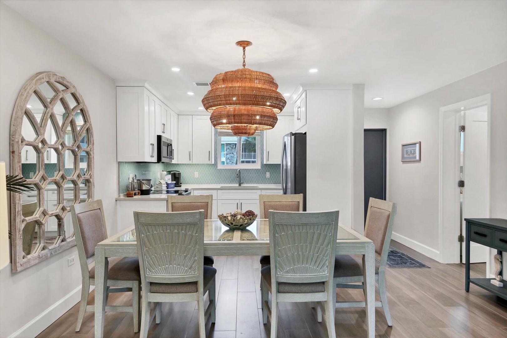 You'll love gathering around this elegant dining table under the stunning woven chandelier, with the fully equipped kitchen just steps away for easy meal prep.