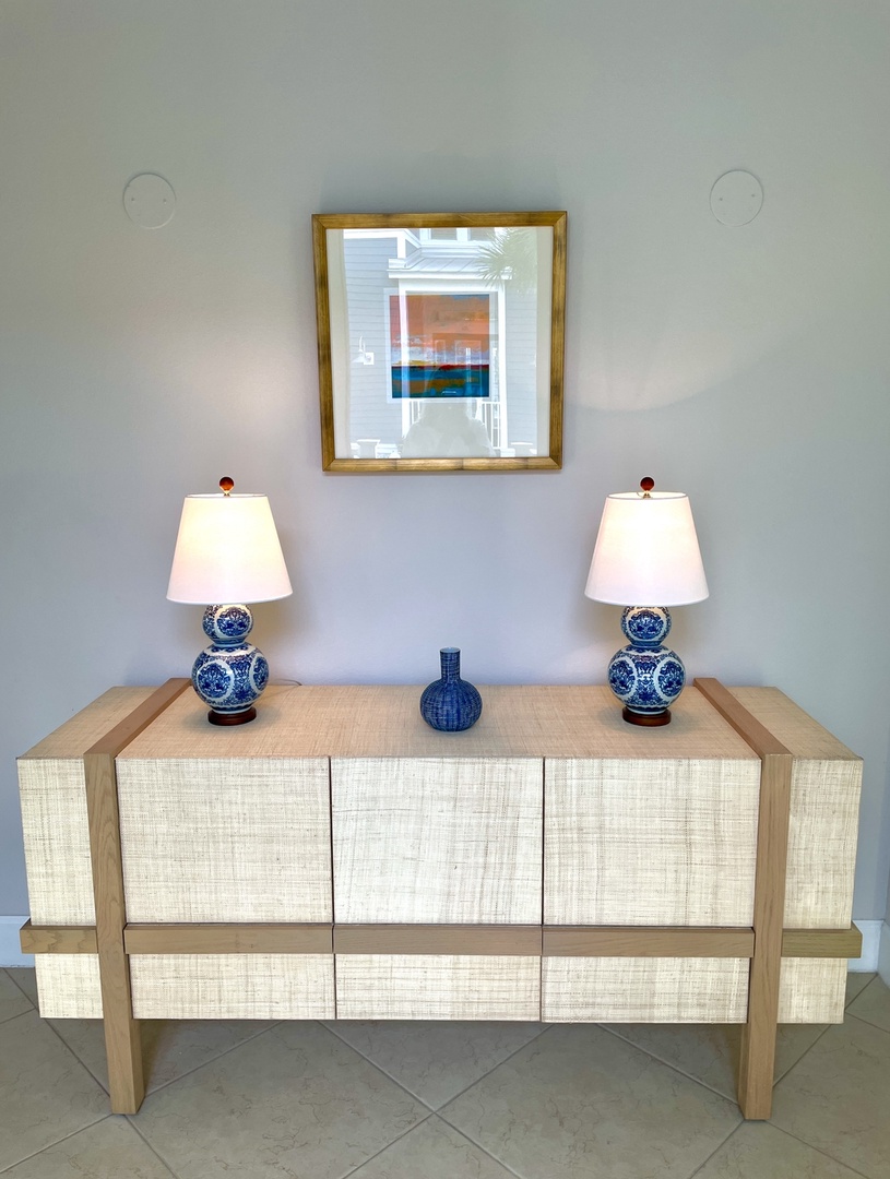 Unwind in your elegantly appointed space, where coastal-inspired artwork and warm ceramic lamps create a sophisticated retreat for relaxation.