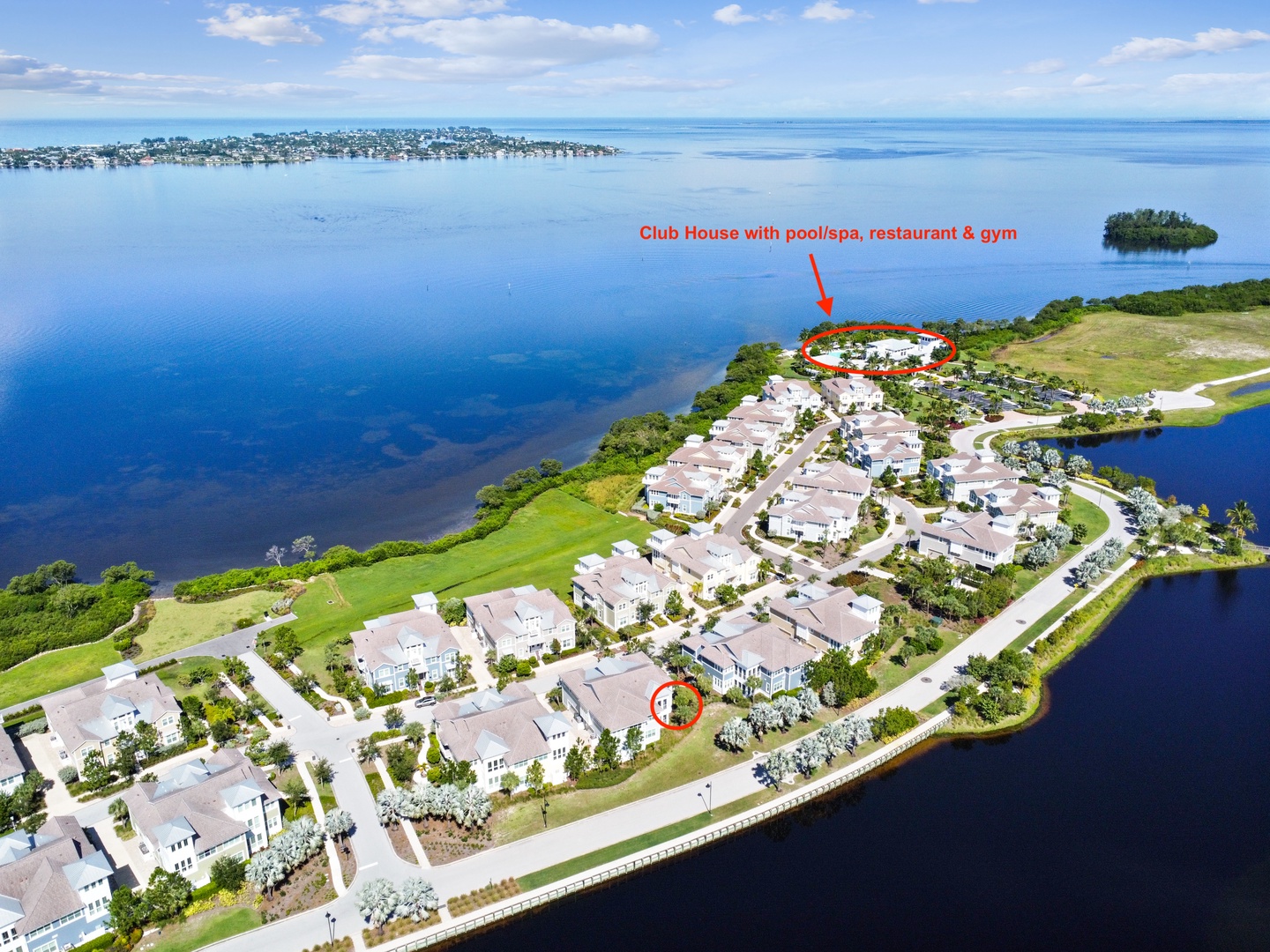 Waterfront resort community featuring clubhouse amenities on scenic coastline with pristine waters and lush landscaping.