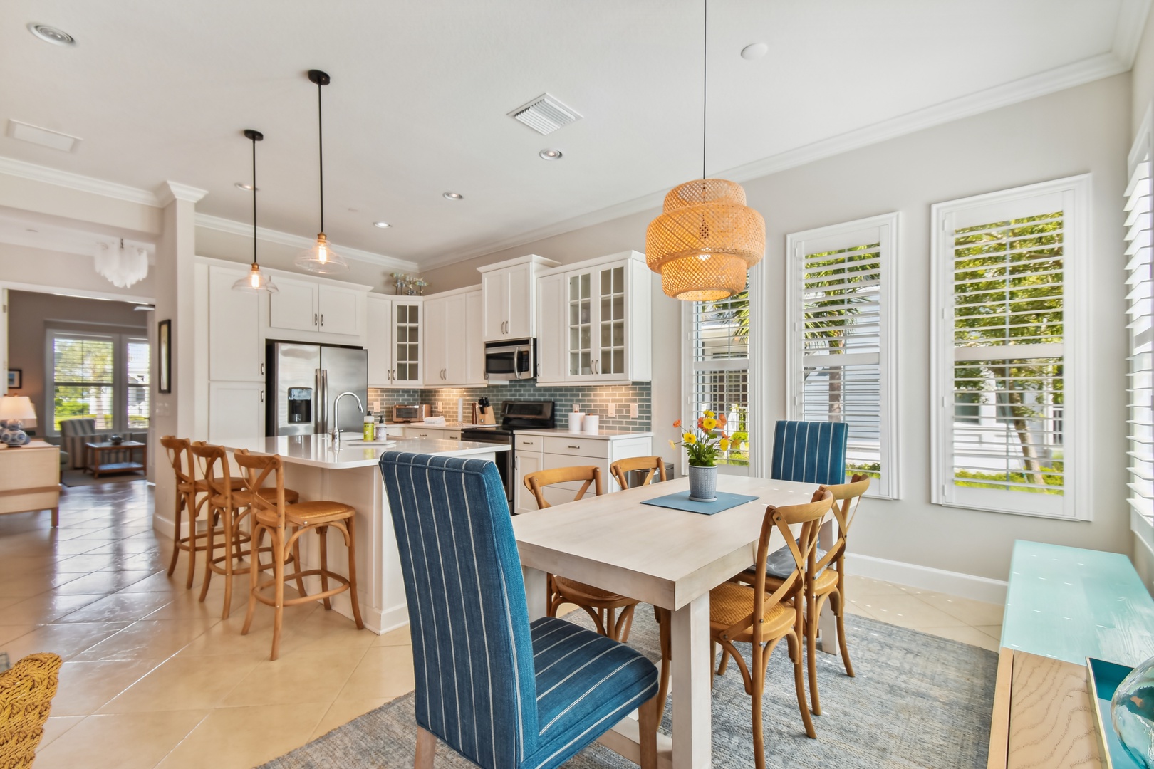 Your bright kitchen and dining space features elegant white cabinetry, warm wood accents, and cozy seating perfect for memorable meals together.