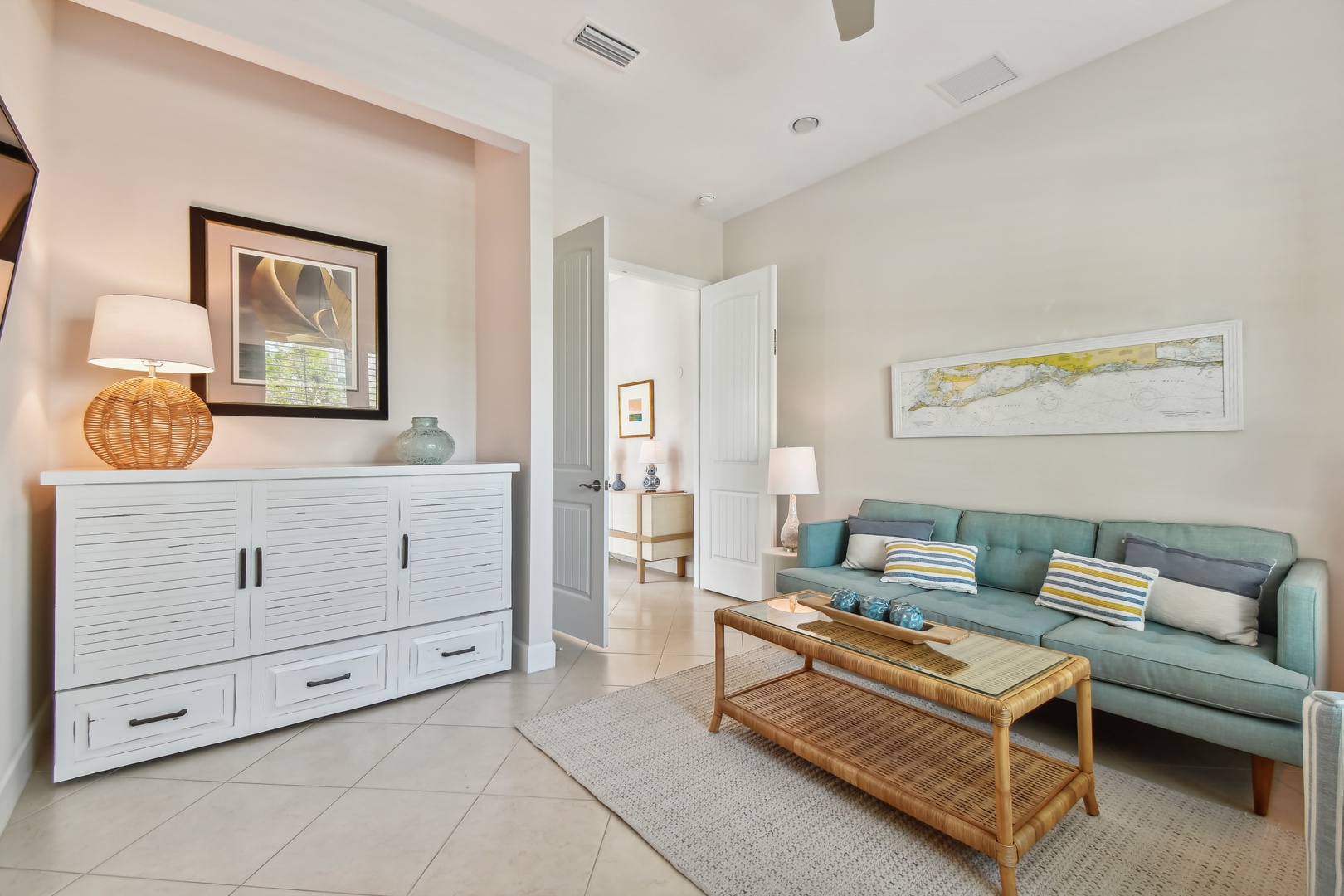 Unwind in your bright living room featuring comfortable seating, coastal decor, and thoughtful touches that create a peaceful retreat.