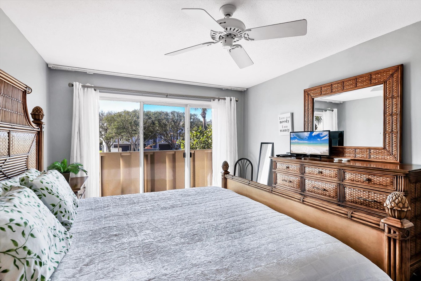 Relax in your peaceful retreat with warm tropical decor, gentle ceiling fan breezes, and natural light streaming through your private balcony doors.