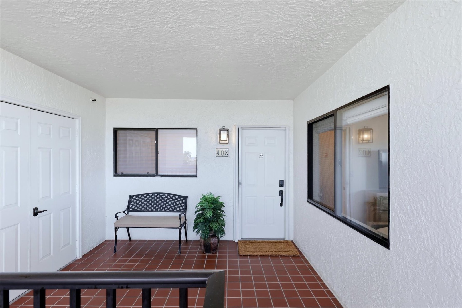 Covered entrance with charming brick floors and a welcoming bench where you can sit and take in the peaceful atmosphere.