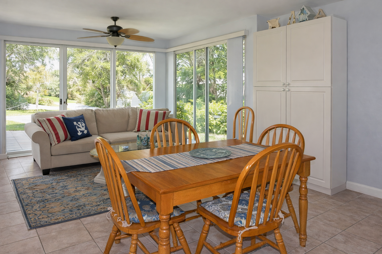 Gather around your bright dining table for meals while enjoying garden views through floor-to-ceiling windows.