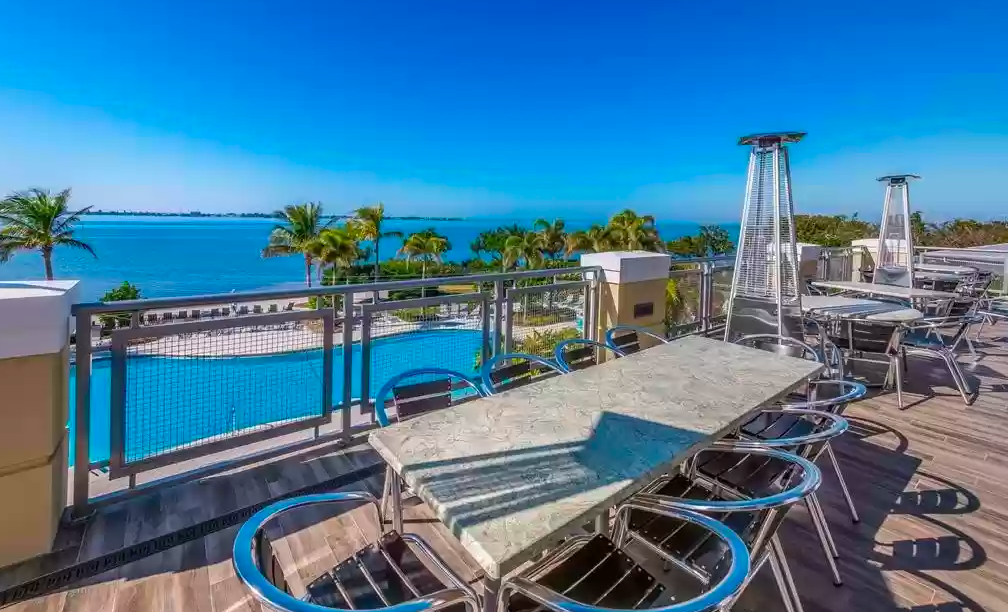 Stunning rooftop terrace with ocean views, pool glimpses, and stylish seating perfect for your tropical getaway.