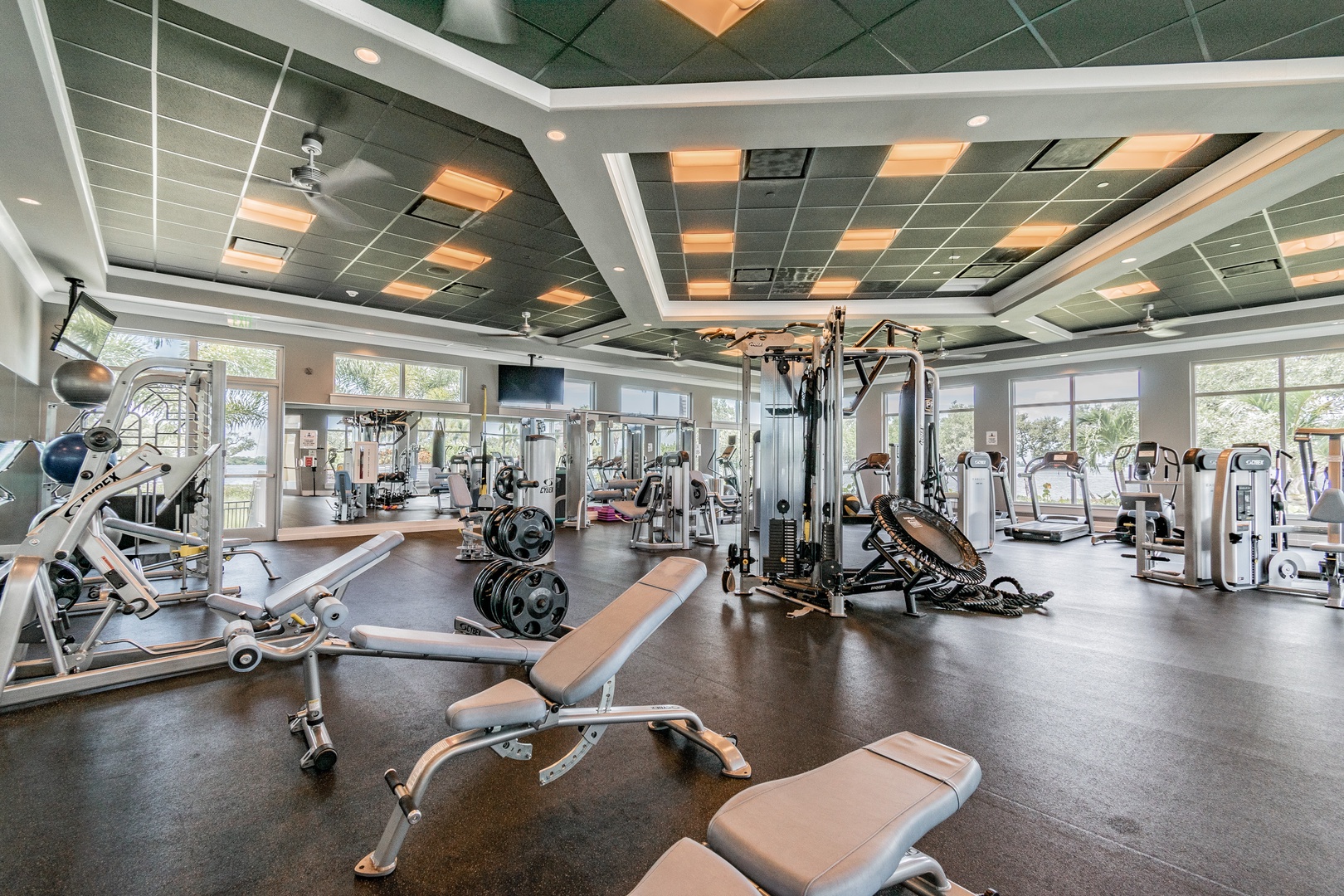 Stay active during your stay in this fully-equipped fitness center featuring modern cardio machines, weight training equipment, and natural light.