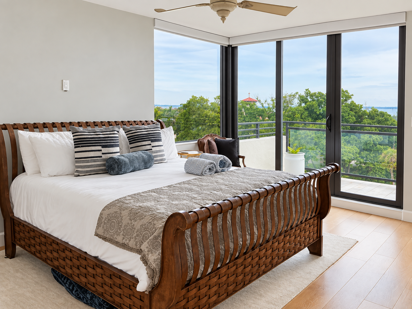 Bright bedroom with balcony water view