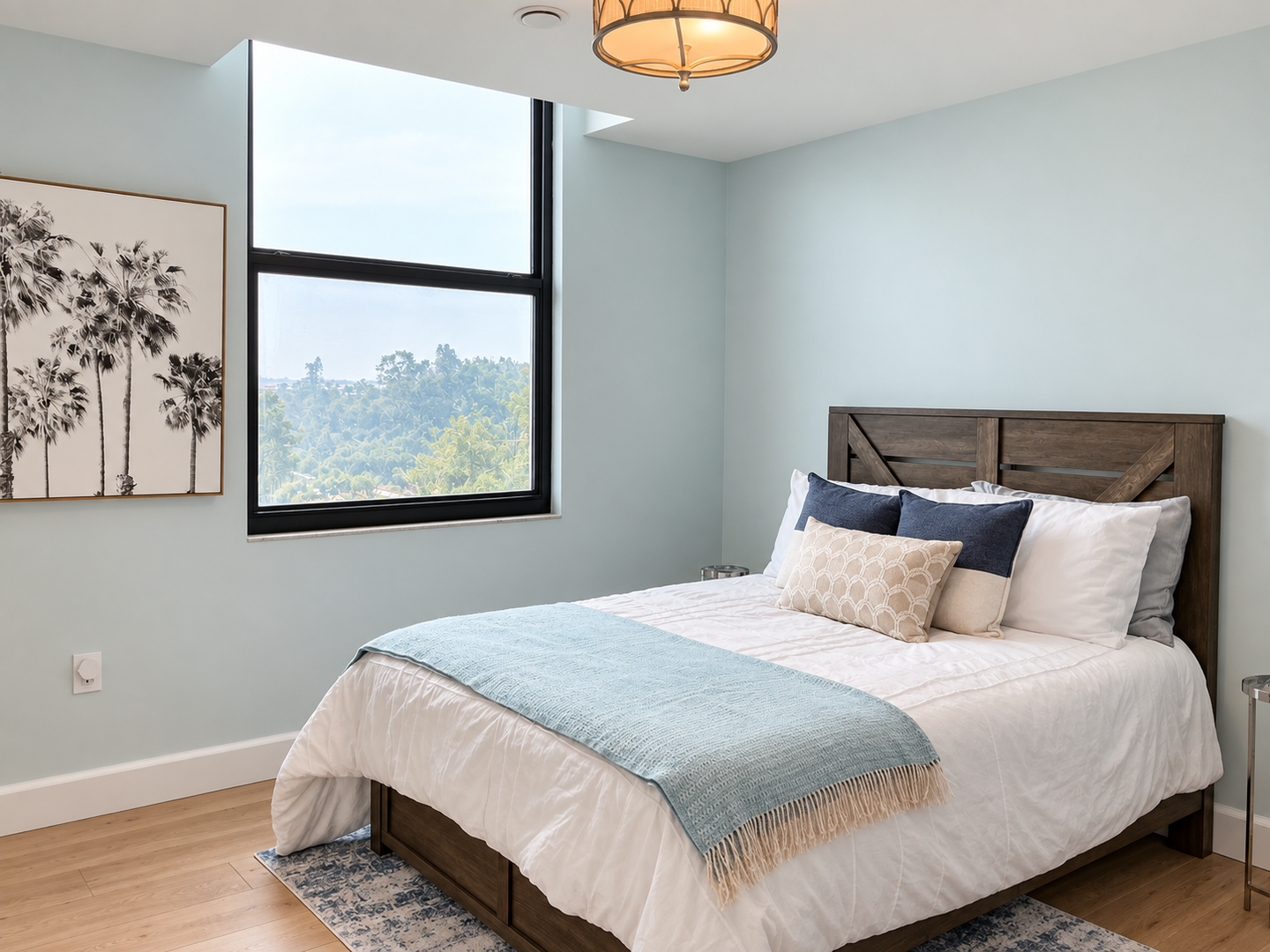 Bright blue-gray bedroom with warm wood