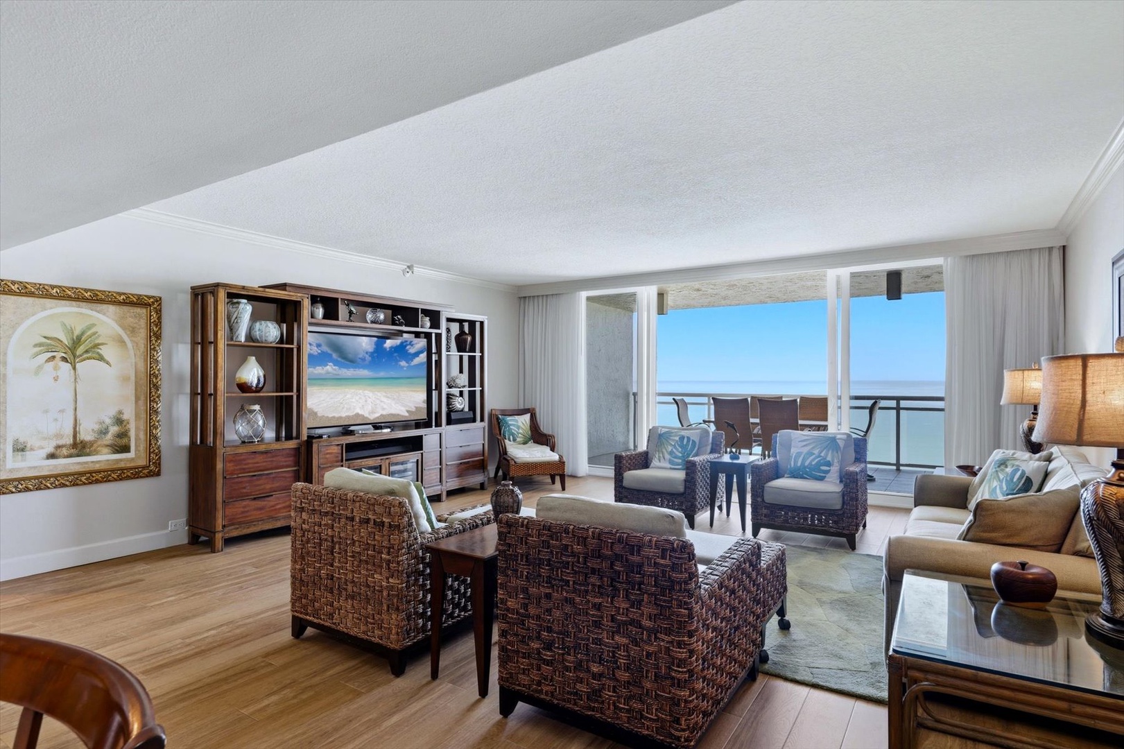 Unwind in your spacious oceanfront living room with stunning sea views and tropical decor that makes every moment feel like paradise.