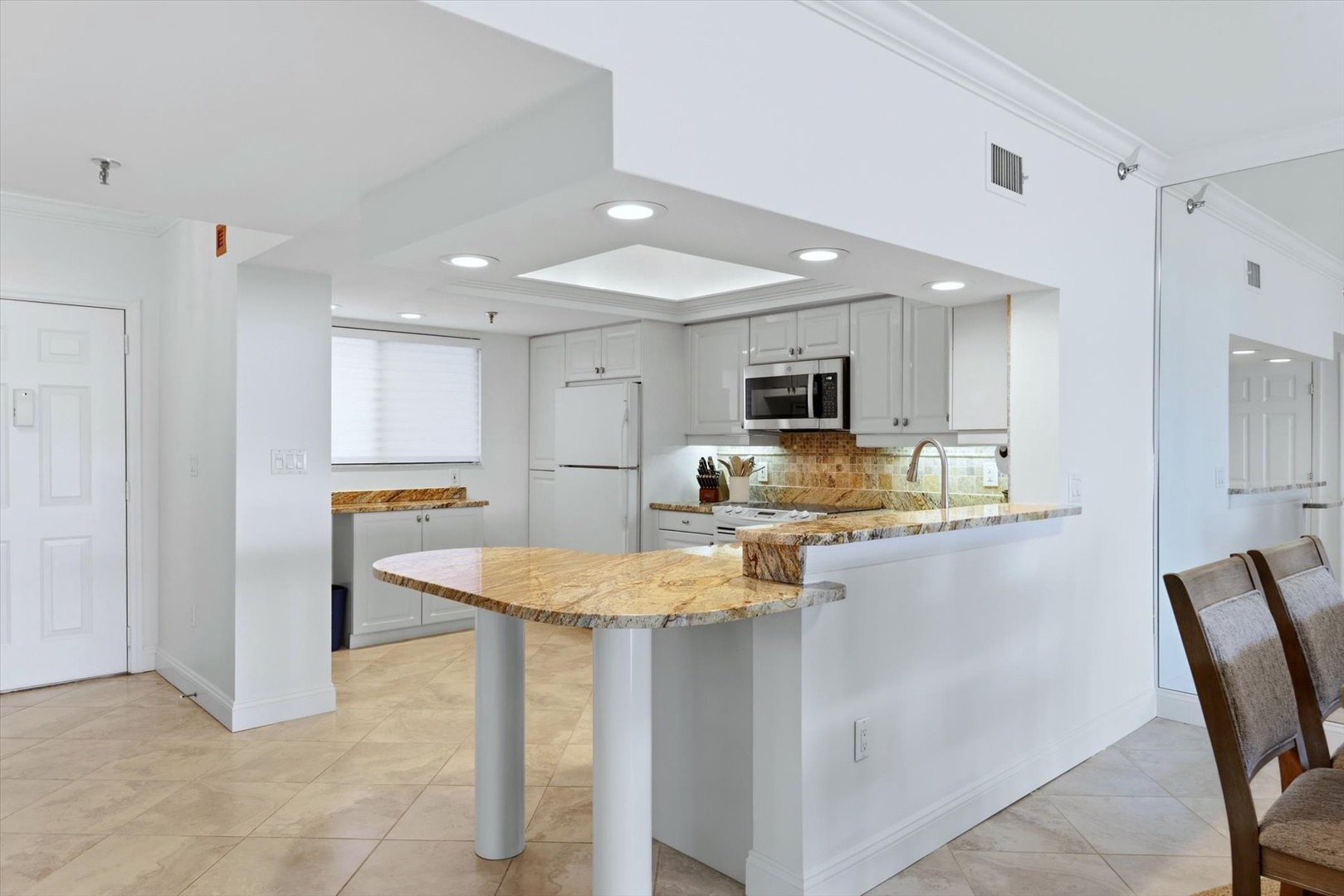 Your gourmet kitchen awaits with granite countertops, modern appliances, and a breakfast bar perfect for morning coffee or evening conversations.