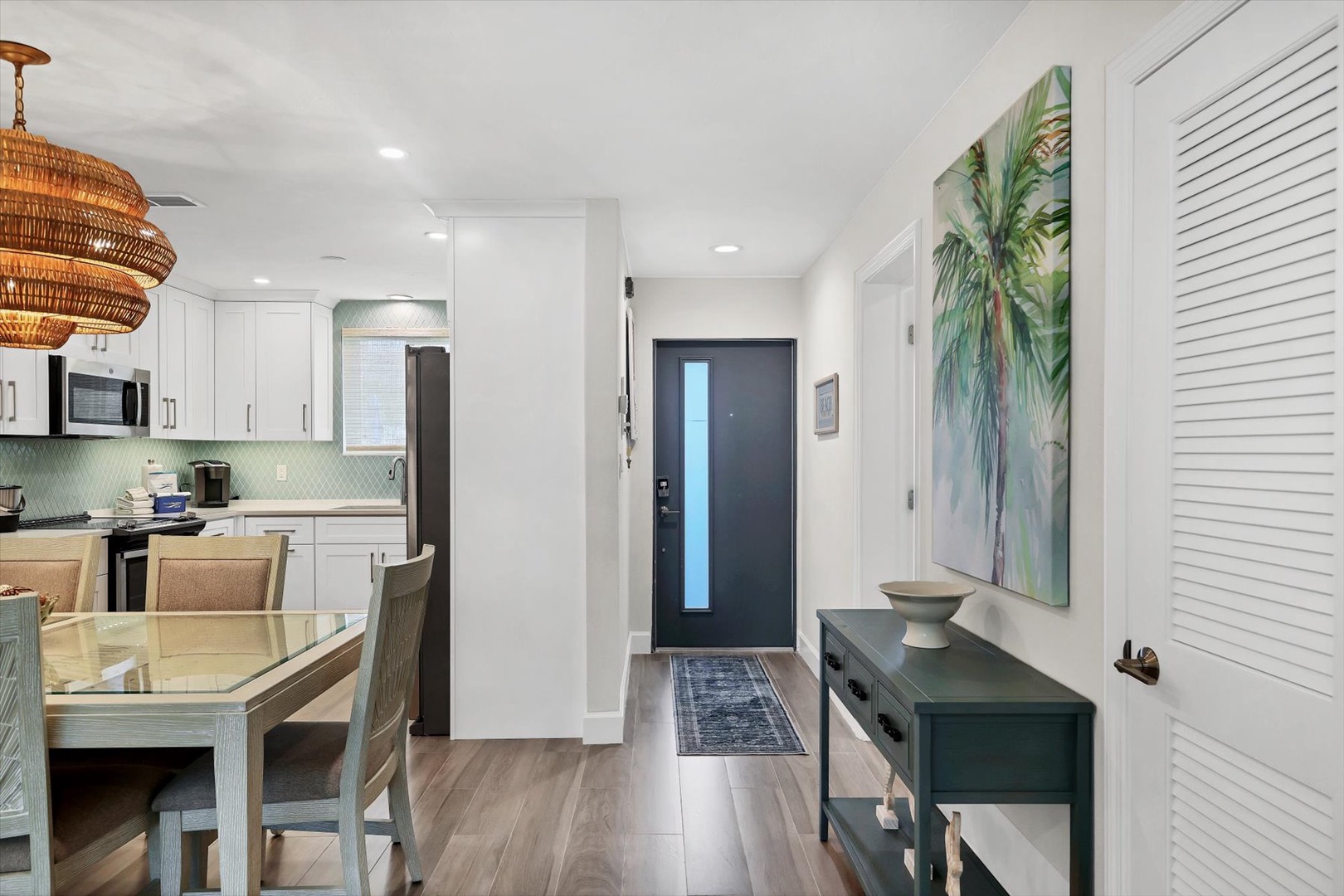 Step into your bright, coastal-inspired retreat where modern comfort meets tropical charm through stunning artwork and thoughtful design touches.