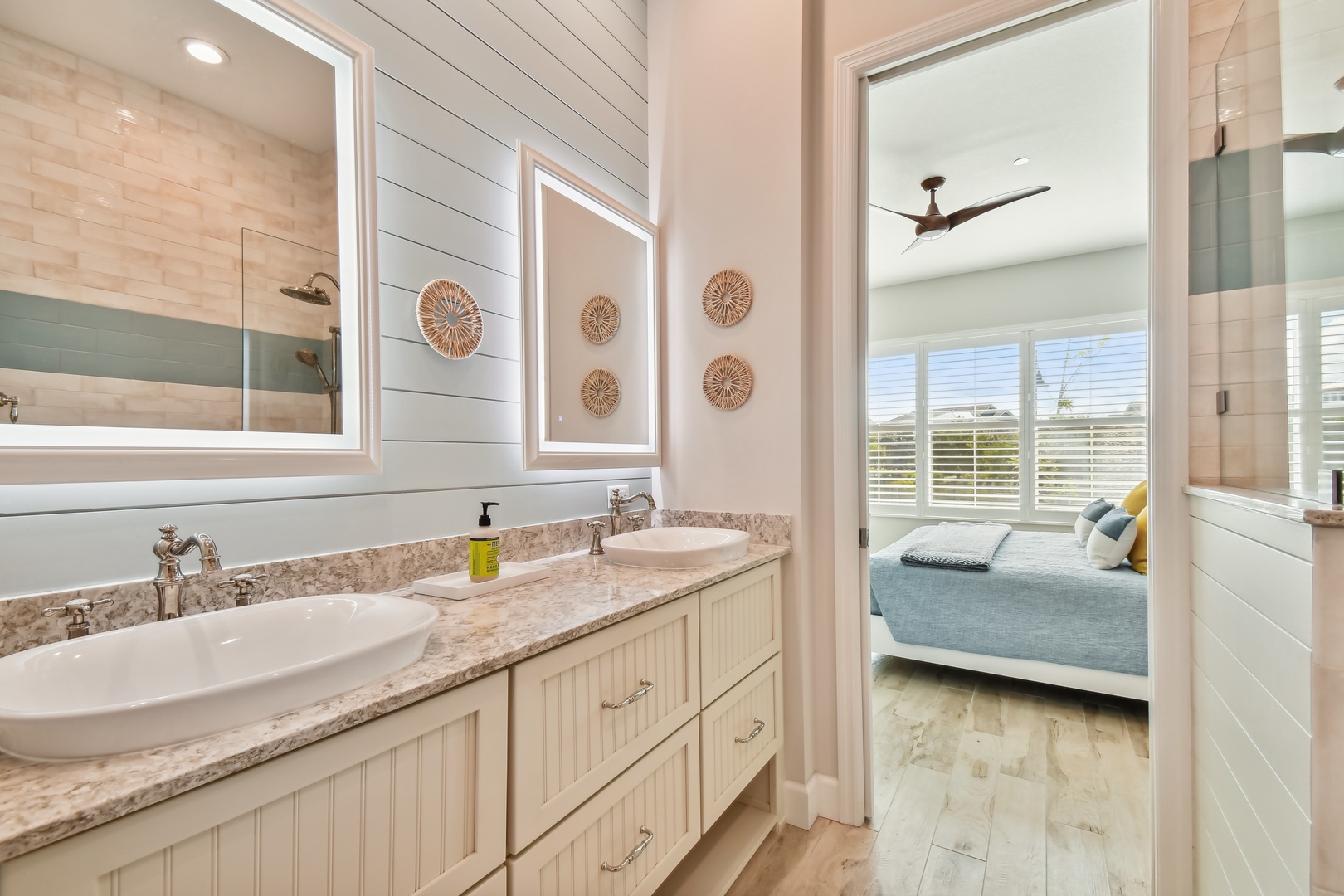 Relax in your coastal-inspired ensuite with double vanity and peek into your serene bedroom sanctuary.