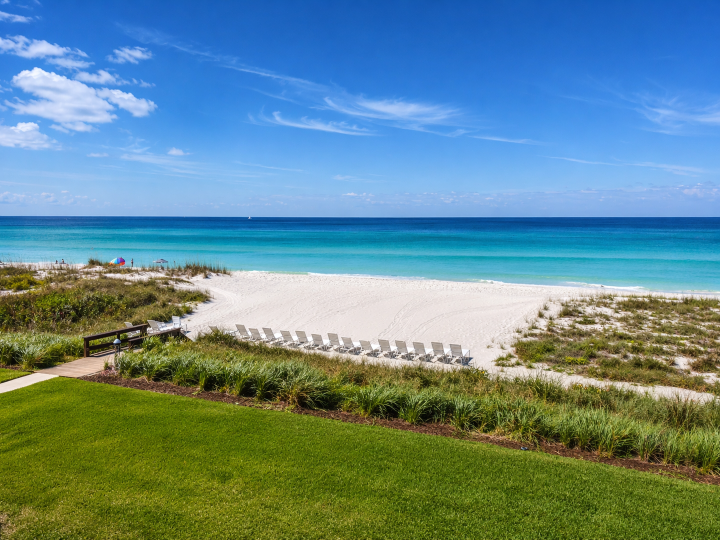 Sunny beach with chairs and dunes