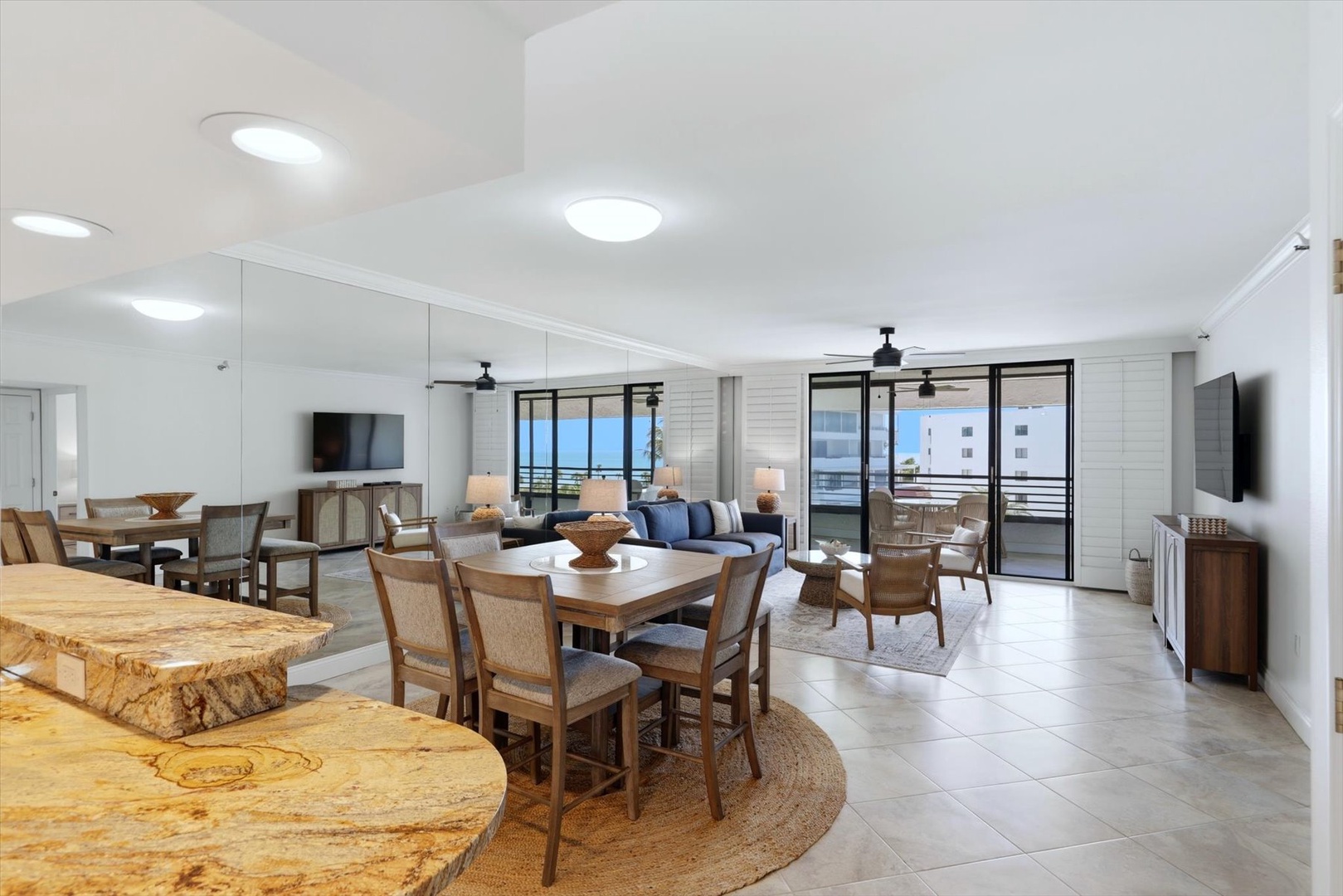 Relax in your spacious open-concept living area with modern kitchen, comfortable seating, and stunning balcony views to enjoy throughout your stay.