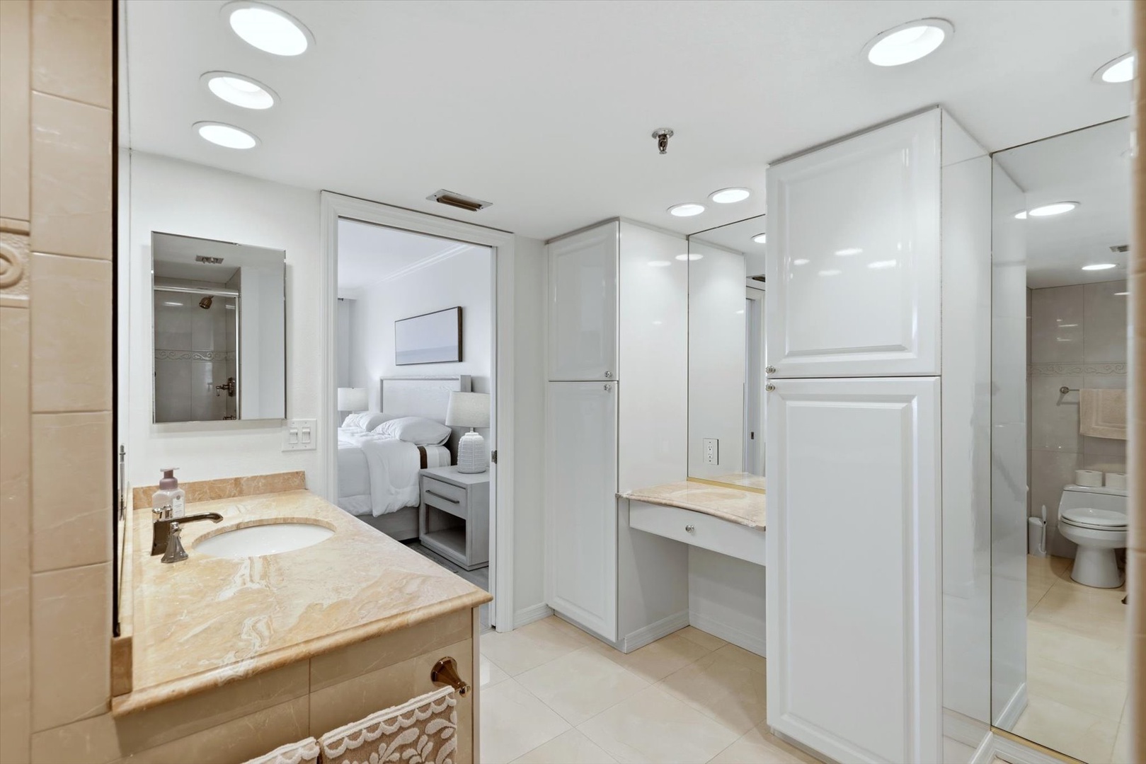 Your marble-finished bathroom features elegant dual vanities and ample storage, creating your perfect getting-ready space.