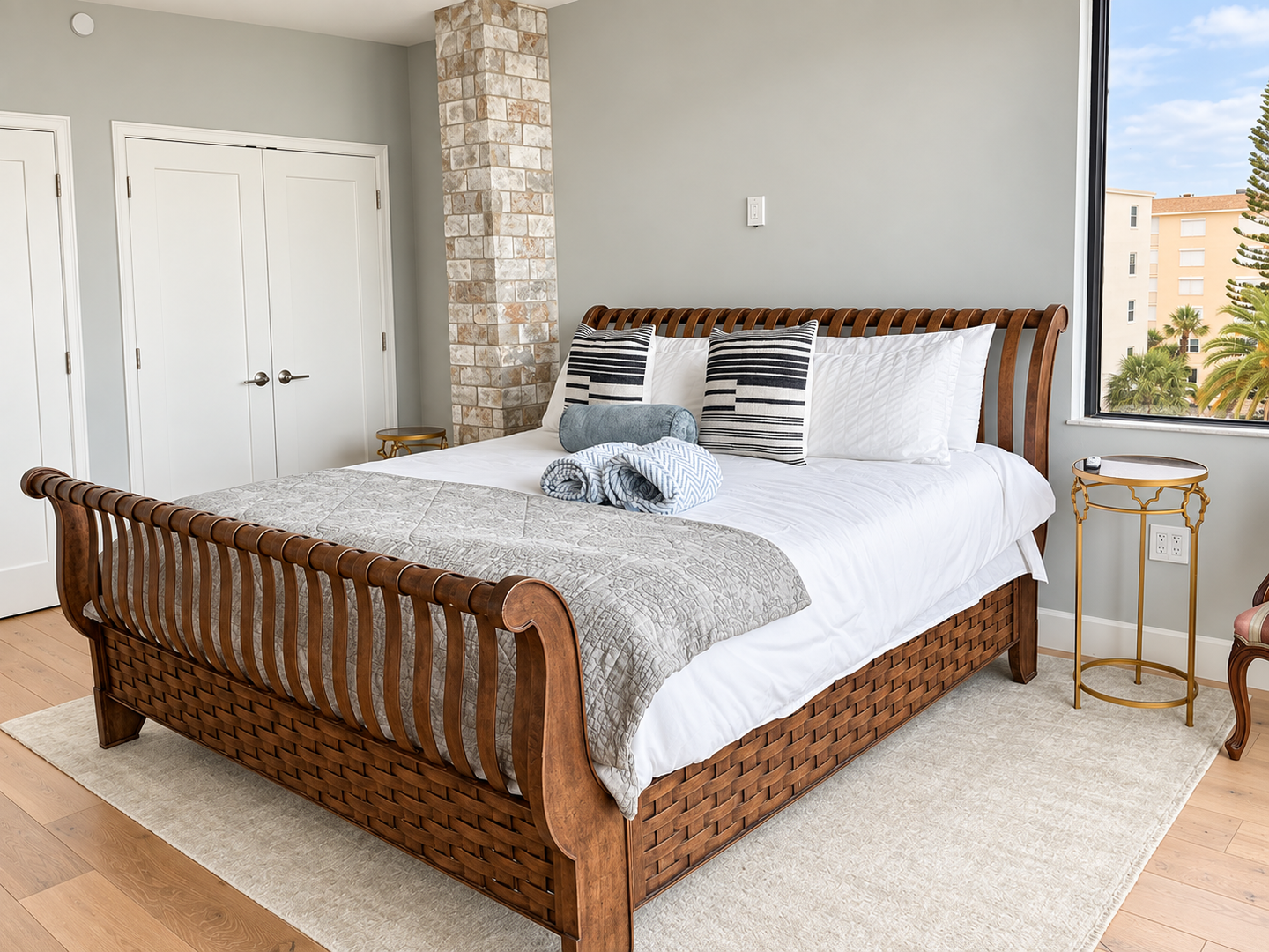 Bright bedroom with wood bed, city view