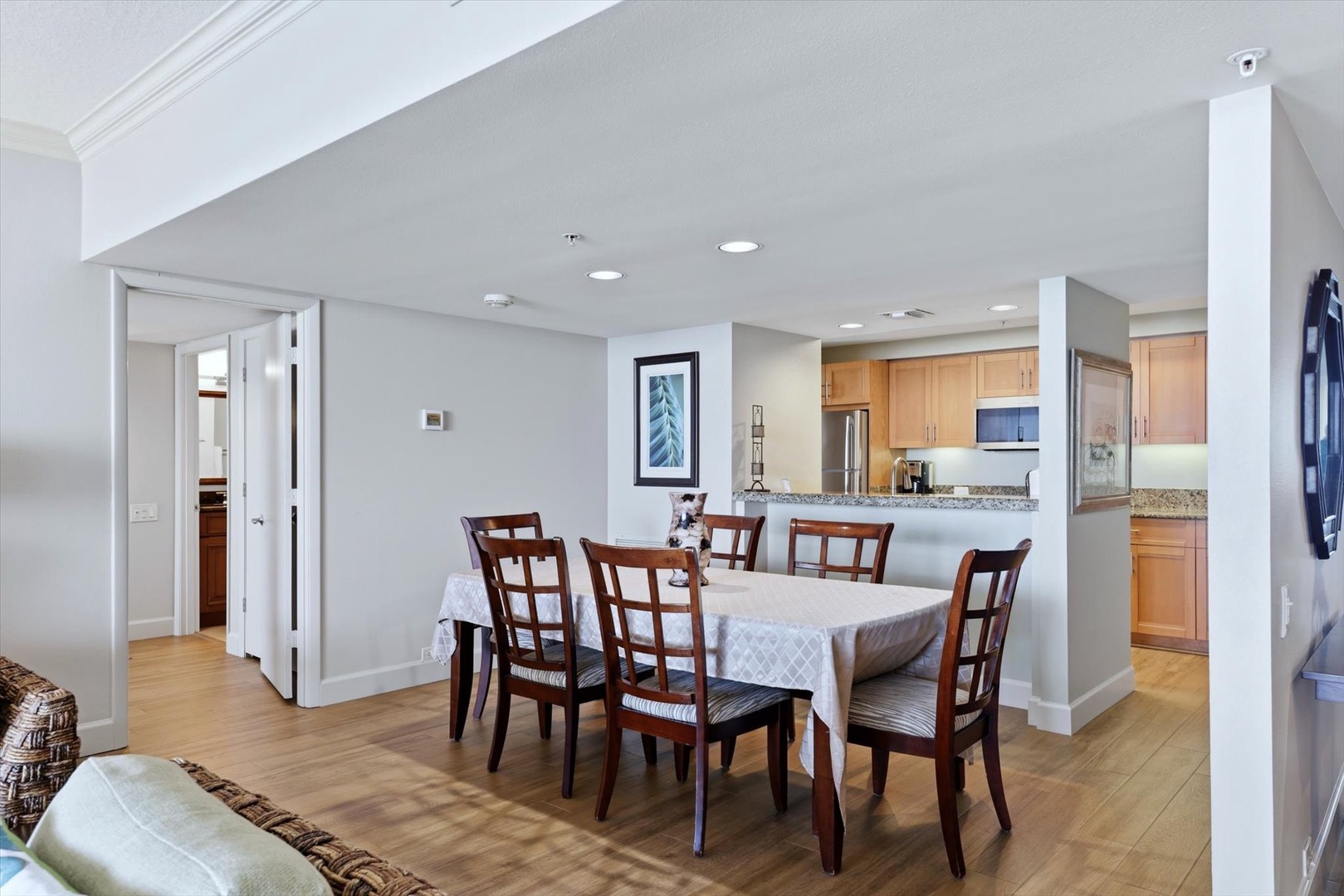 Gather around this elegant dining table where memorable meals await, perfectly positioned between your spacious kitchen and cozy living area.