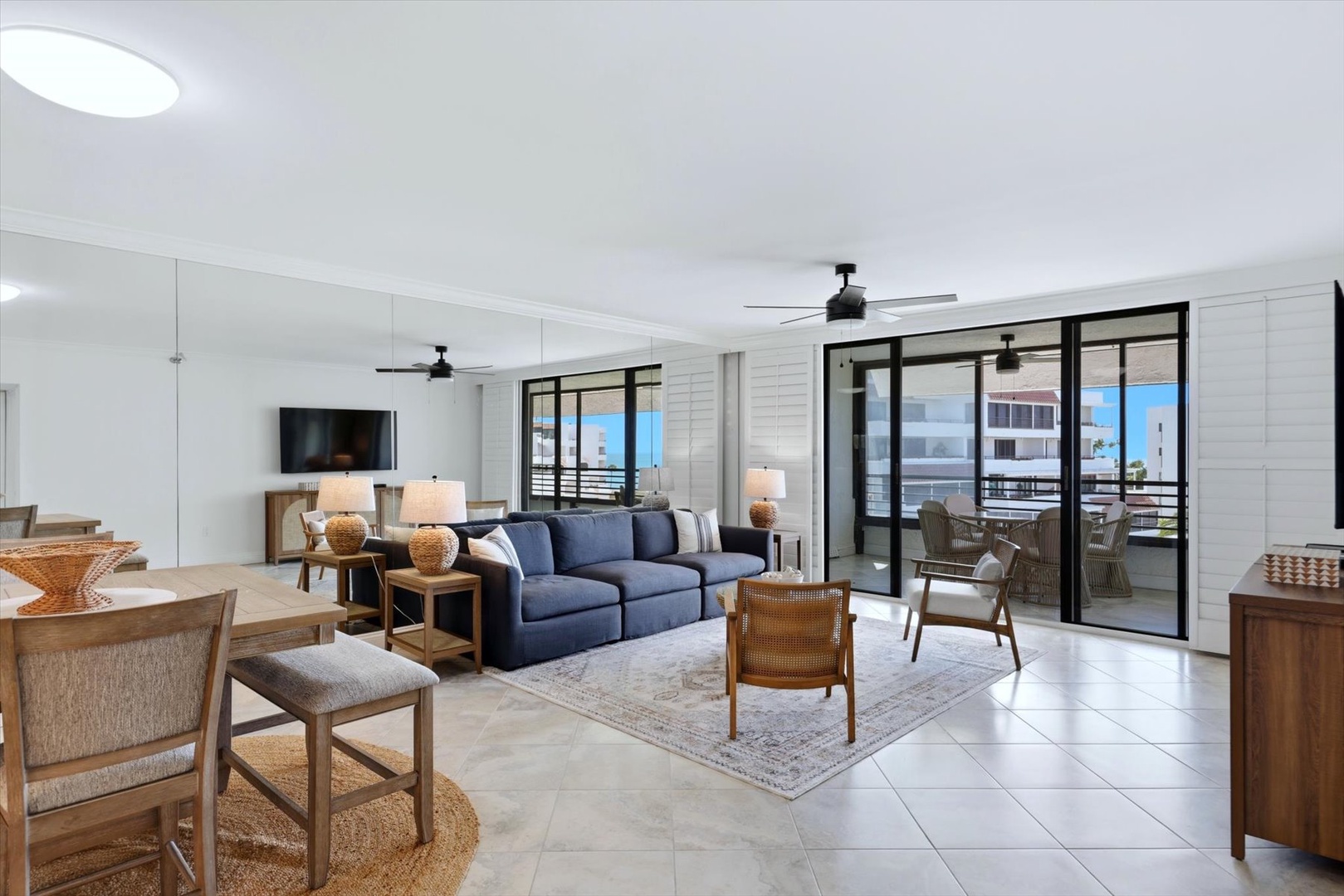 Sink into the plush navy sofa and enjoy your private balcony retreat through floor-to-ceiling windows in this bright, contemporary space.