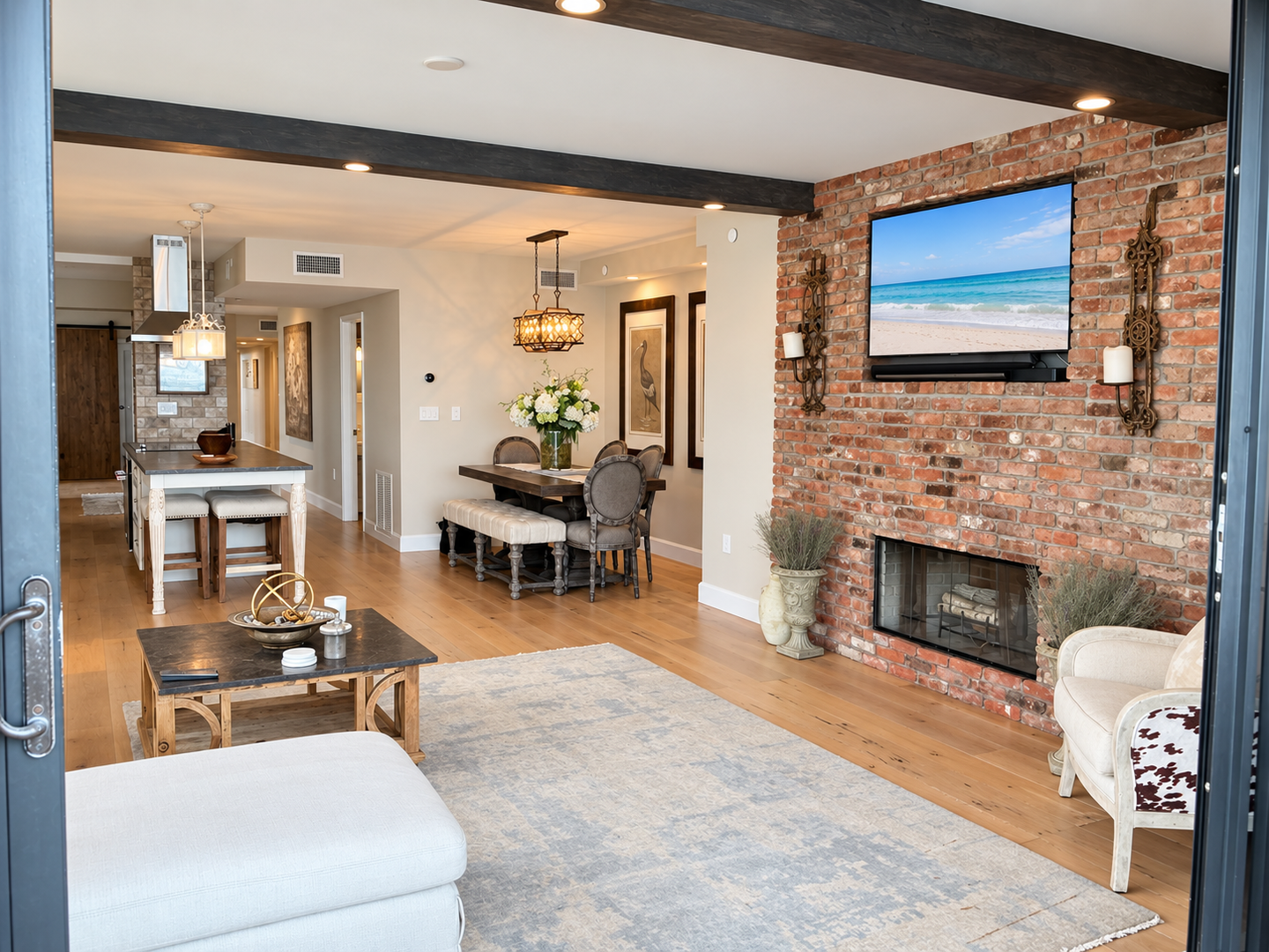 Bright living room, brick fireplace, beach TV
