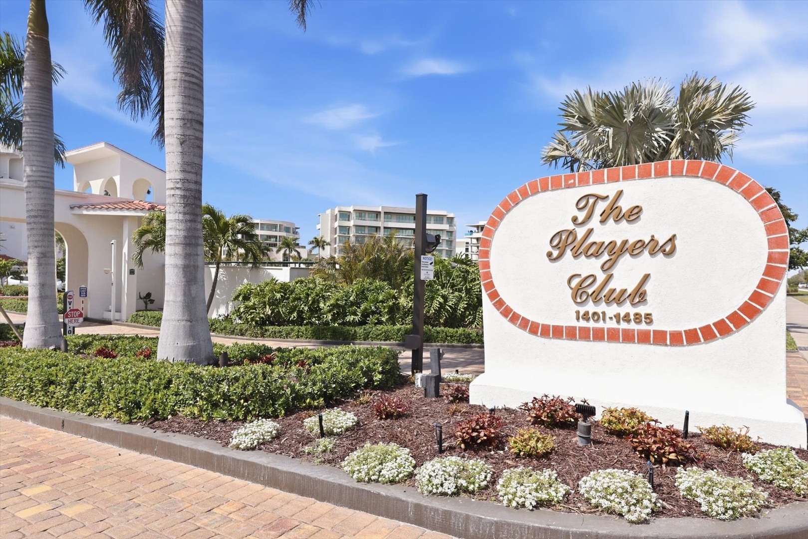 The Players Club entrance welcomes visitors with tropical landscaping and coastal architecture in this resort community.