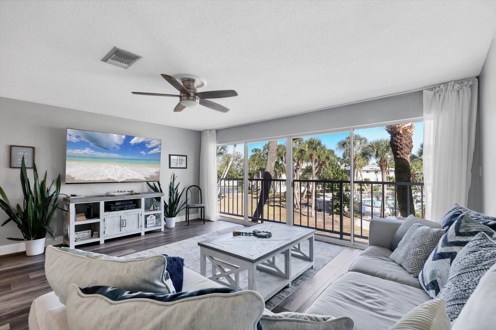 Unwind in your bright living space with tropical views through sliding glass doors onto your private balcony.