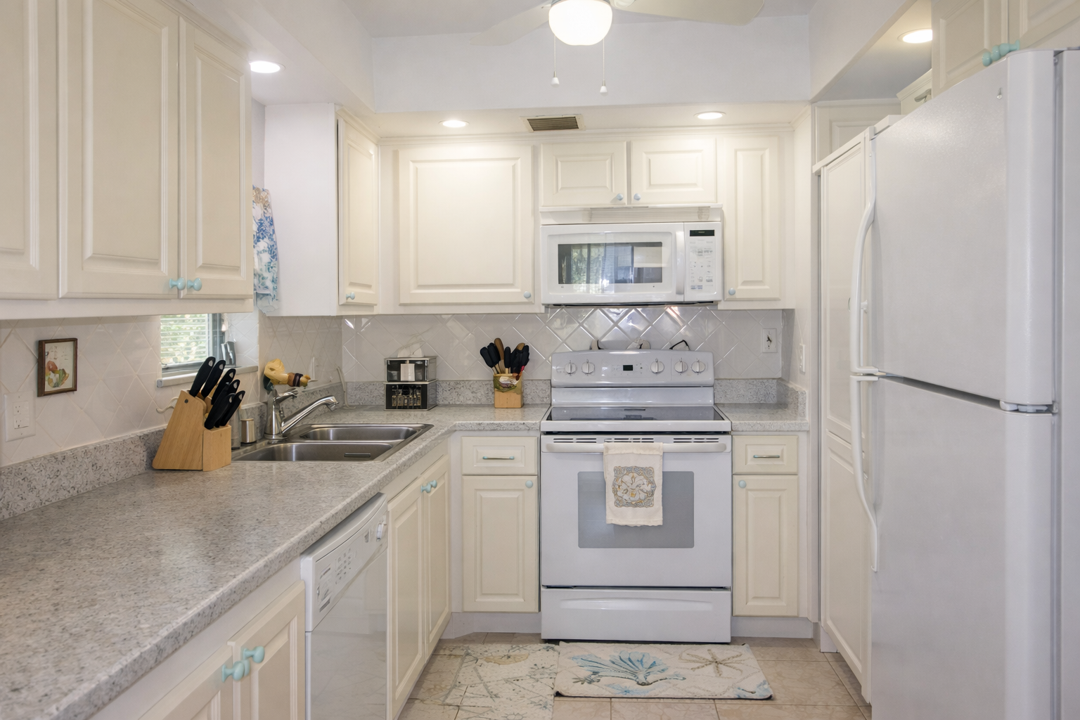 Your fully equipped kitchen awaits with granite counters, white cabinets, and everything needed to create memorable meals together.