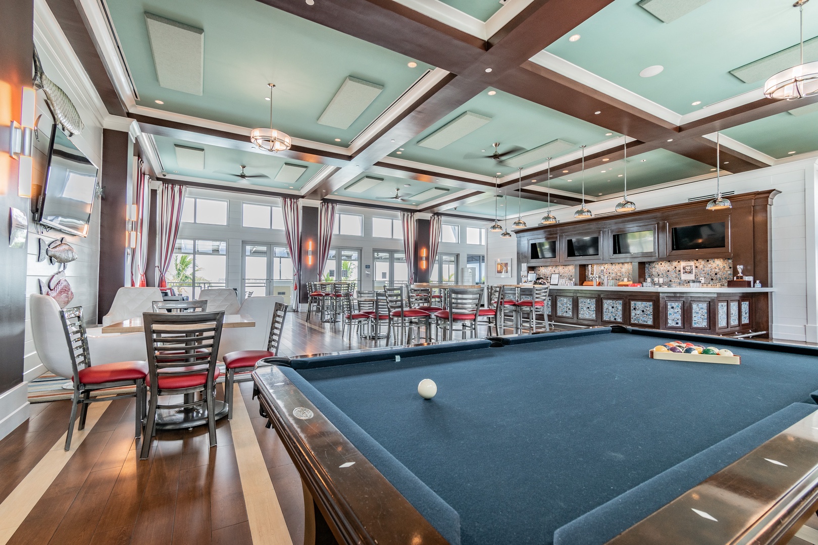Challenge friends to pool while enjoying drinks at the elegant bar in this sophisticated game room with coffered ceilings.
