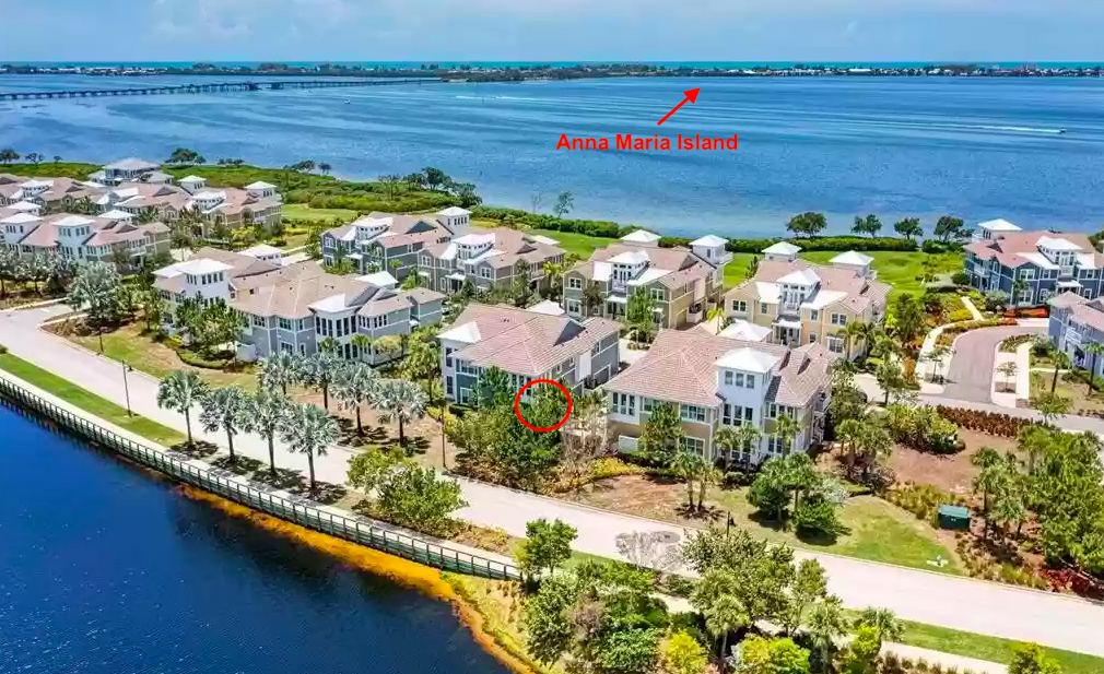 Waterfront community with elegant homes nestled along pristine shores, offering spectacular bay views and Anna Maria Island on the horizon.