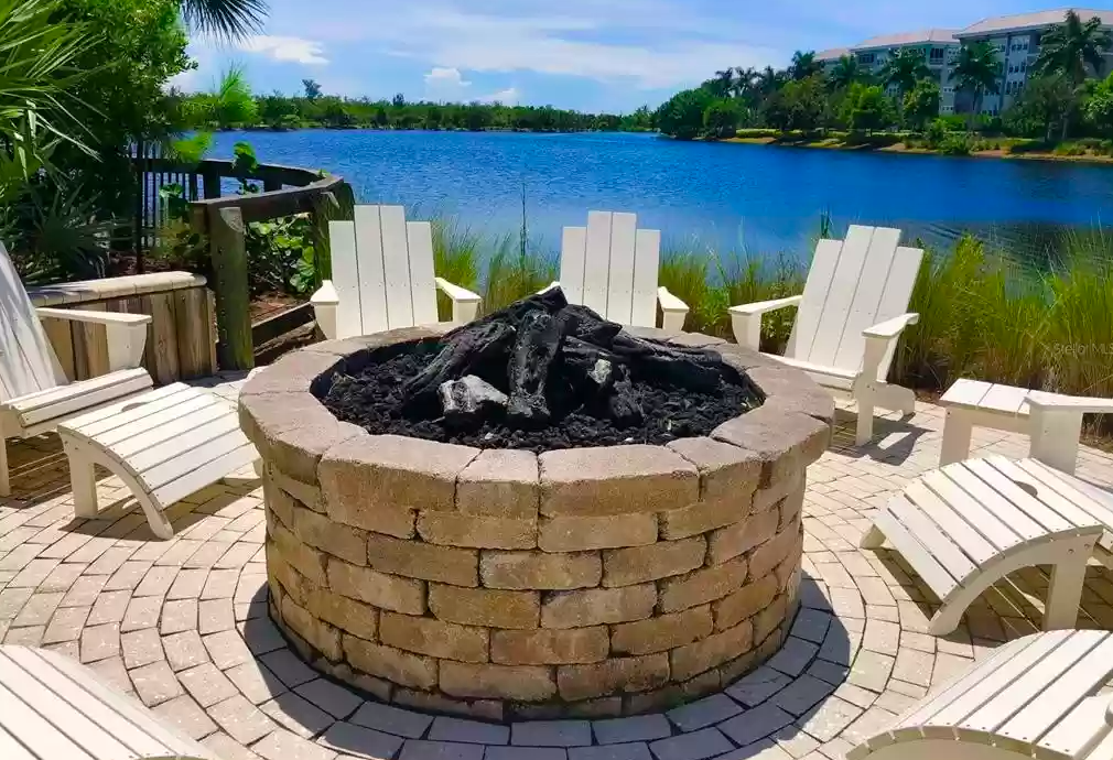 Gather around the stone fire pit with lake views stretching beyond your private retreat.
