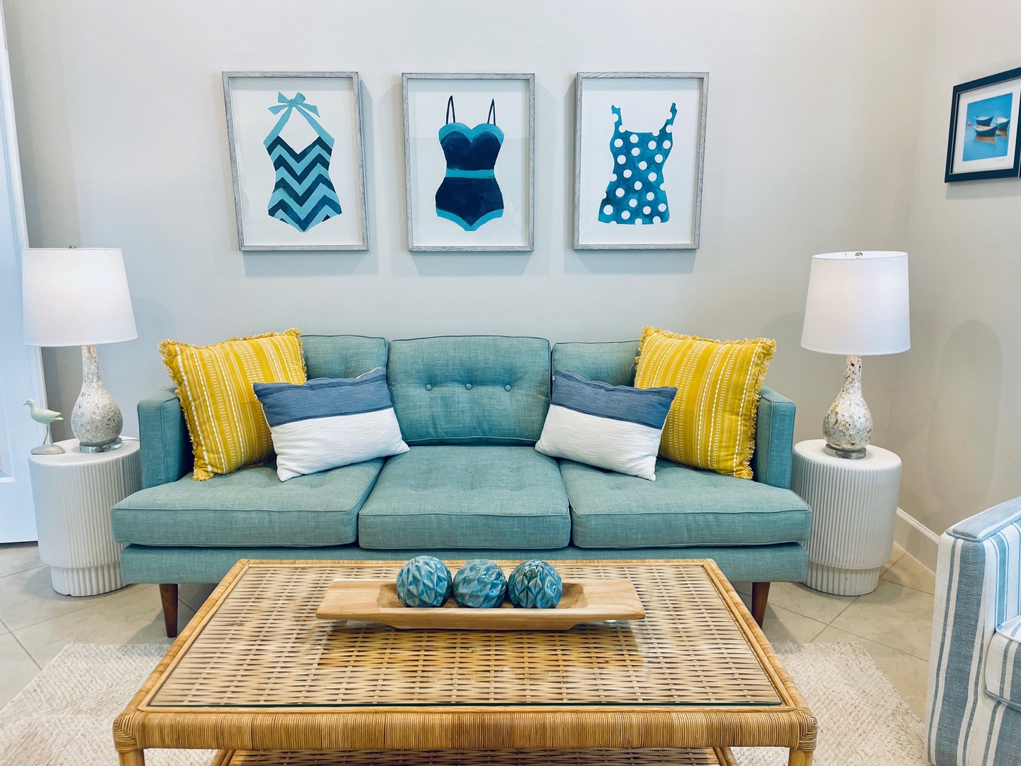 Sink into your cozy turquoise sofa surrounded by cheerful coastal artwork and sunny yellow accents that brighten your home away from home.