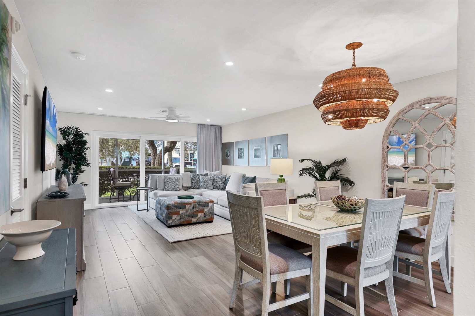 Unwind in your stylish open-plan living space where modern comfort meets coastal charm, featuring elegant furnishings and abundant natural light.