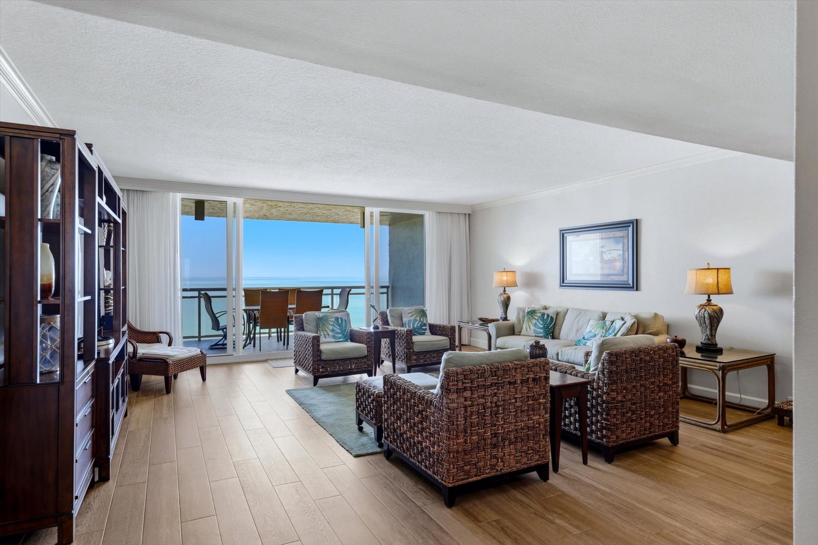 Your oceanfront living room opens to endless sea views through floor-to-ceiling windows, where tropical breezes and stunning sunsets await.