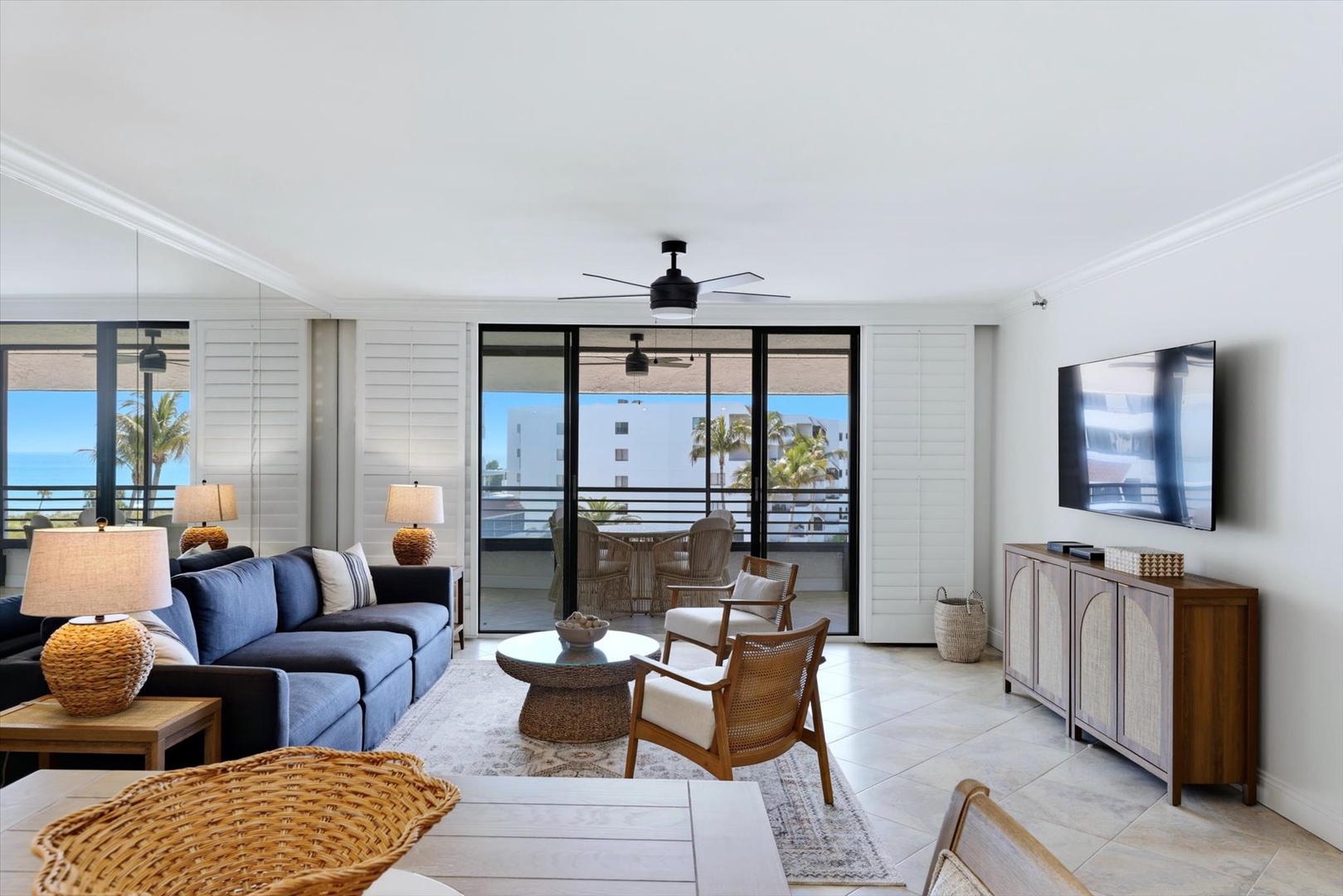 Relax in this bright, stylish living room with ocean views through floor-to-ceiling windows and your private balcony just steps away.