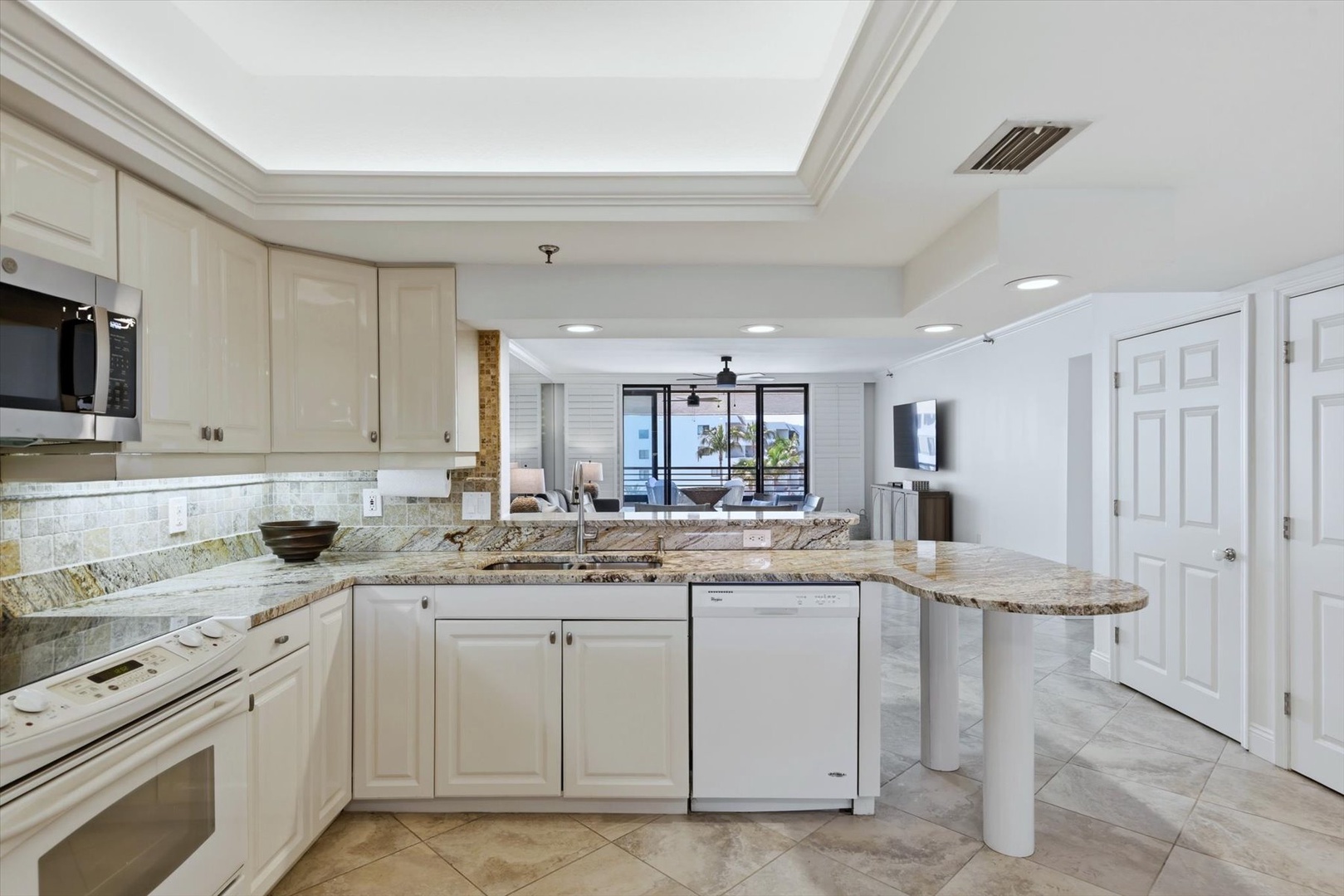 Cook with ease in your fully-equipped kitchen featuring granite counters, modern appliances, and an open layout that flows into the living space.
