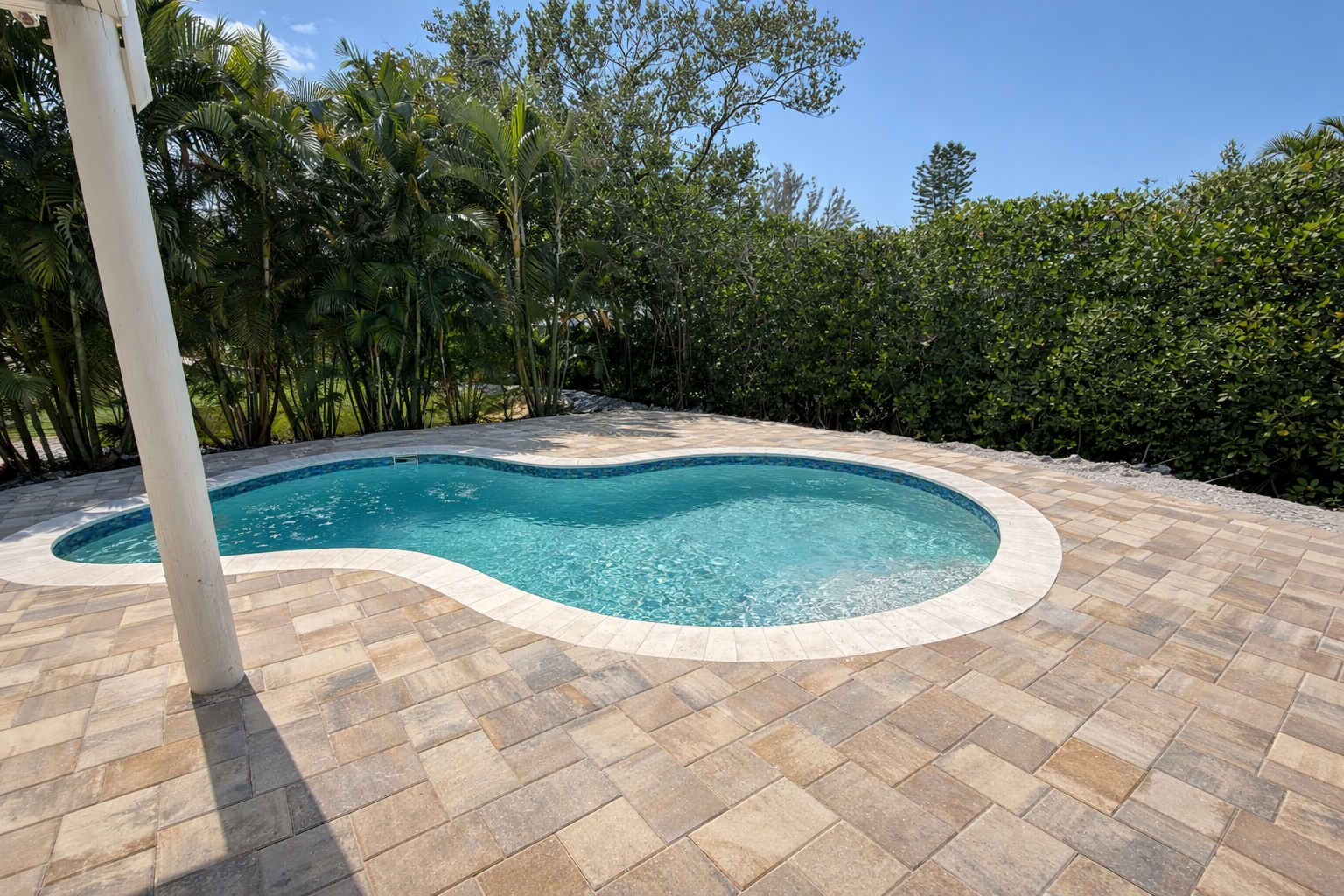 Dive into your private oasis surrounded by lush tropical palms and vibrant greenery, where crystal-clear waters invite endless relaxation.