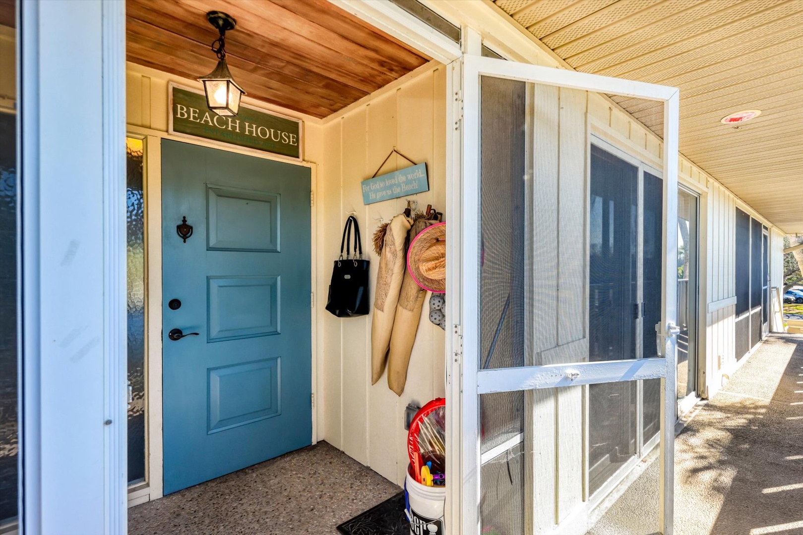 Step into your Beach House retreat where coastal charm meets comfort. Your beach gear awaits by the turquoise door, ready for sandy adventures.