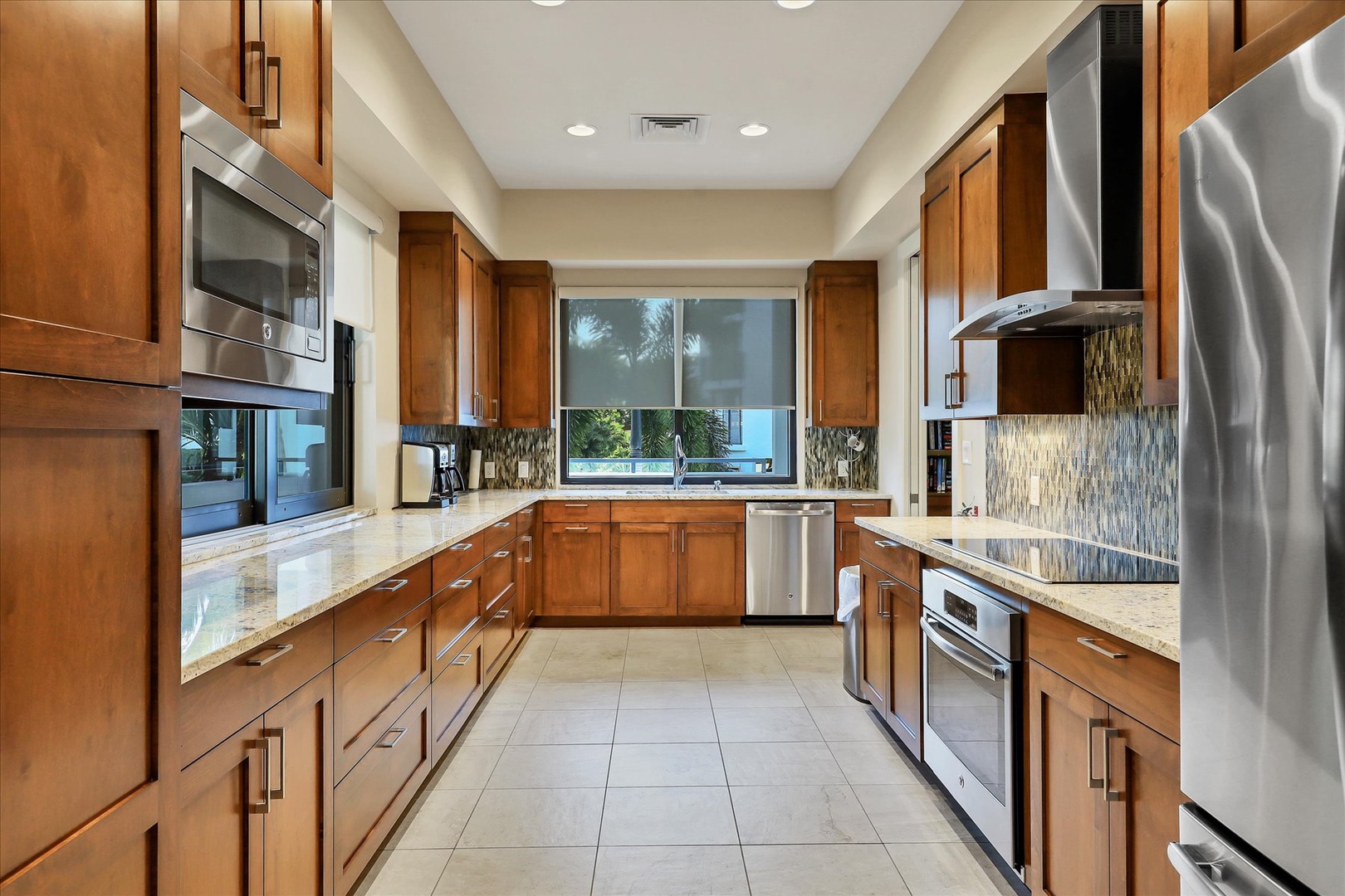 This gourmet kitchen with warm wood cabinets and granite counters invites you to create memorable meals together.