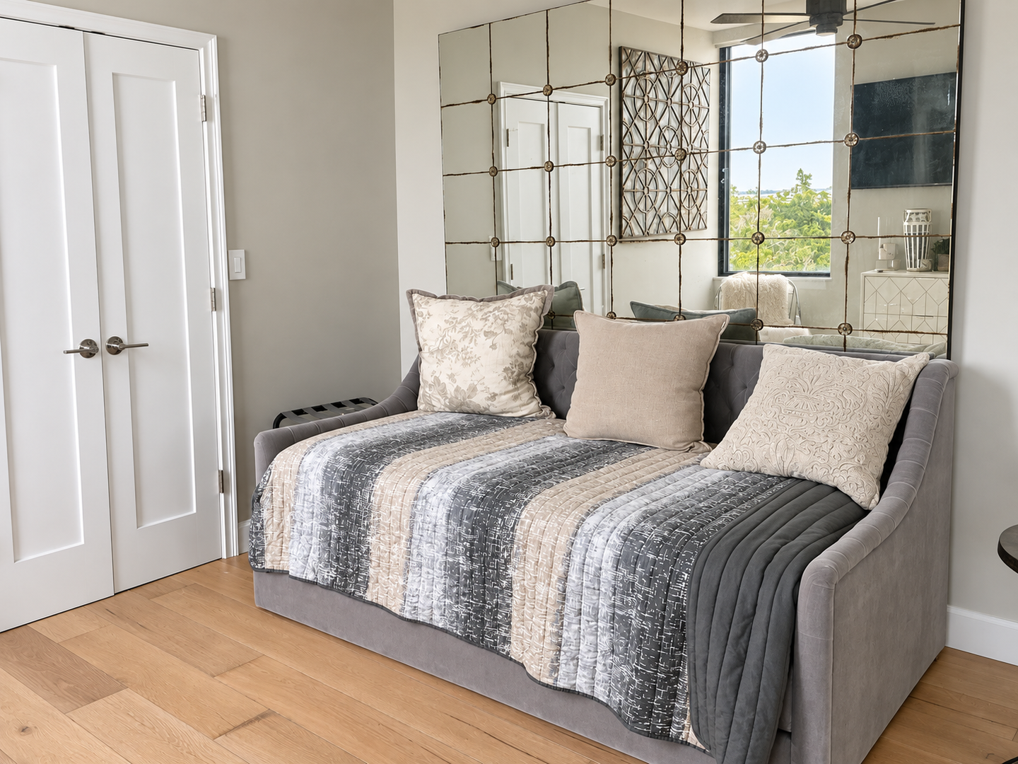 Elegant gray daybed by mirrored wall