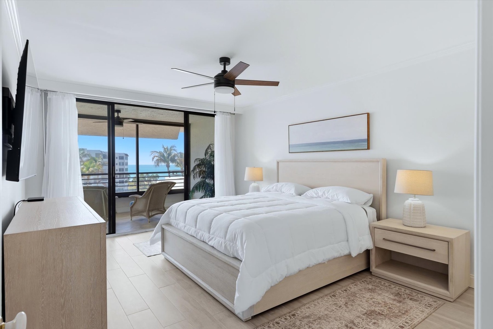 Drift off to sleep with ocean breezes and sea views from your private balcony in this serene bedroom retreat.