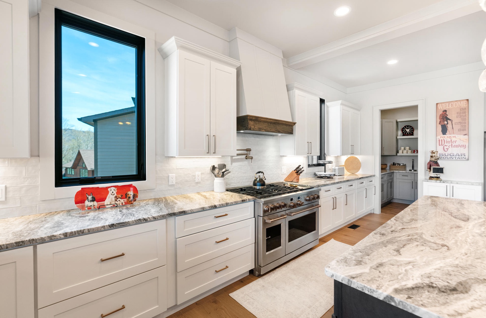 Your spacious gourmet kitchen awaits with gleaming countertops, professional appliances, and charming touches that make cooking feel effortless and joyful.